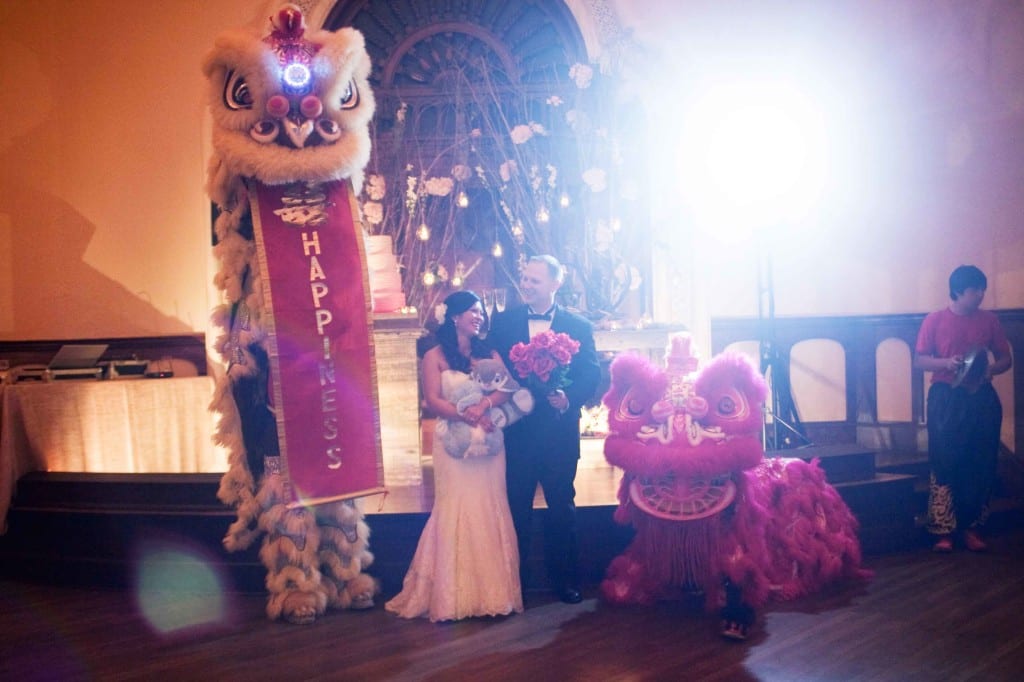 bride and groom with dragon dancers