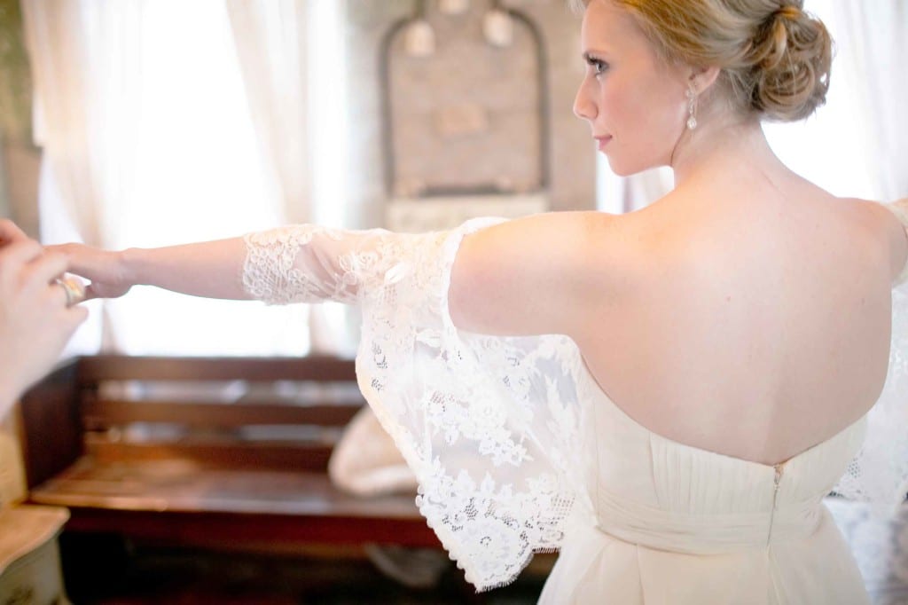 bride putting on lace valero