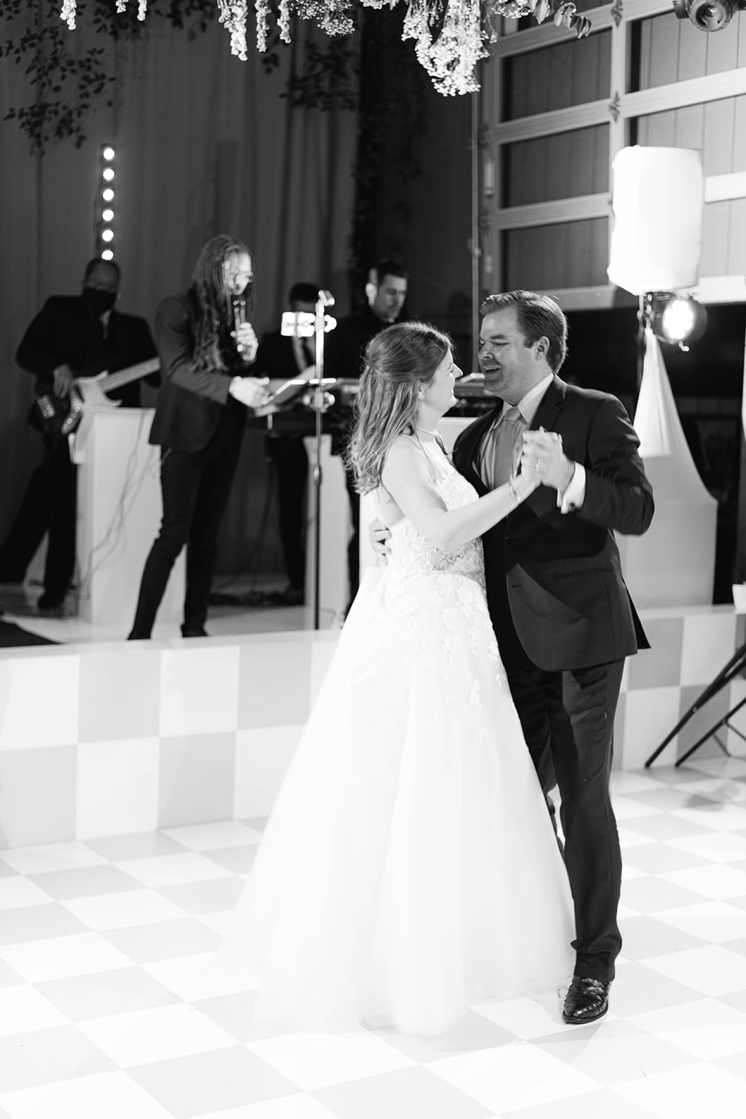 Bride and Groom Dancing on Checkered Dance Floor