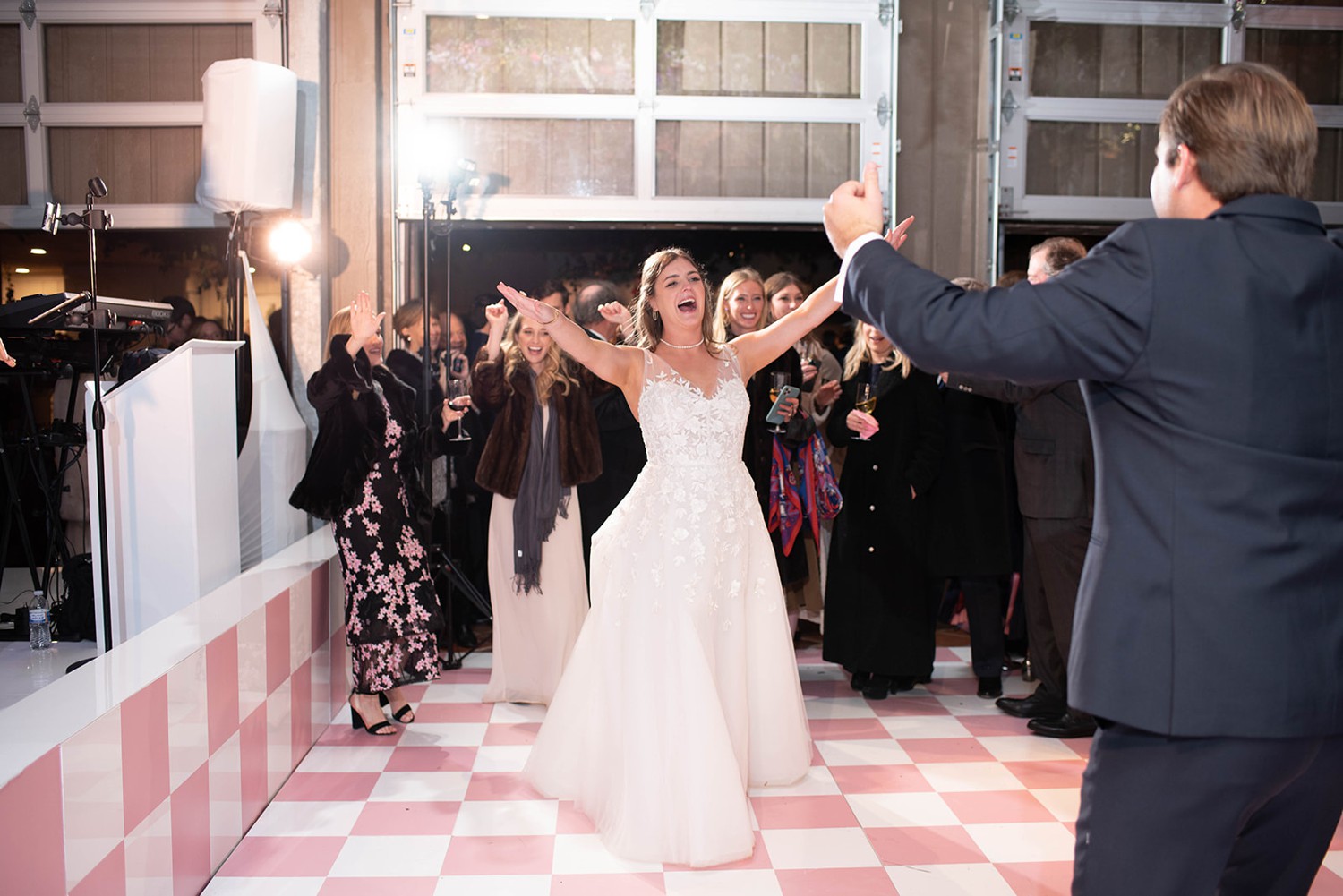 Bride dancing on pink checkered dance floor
