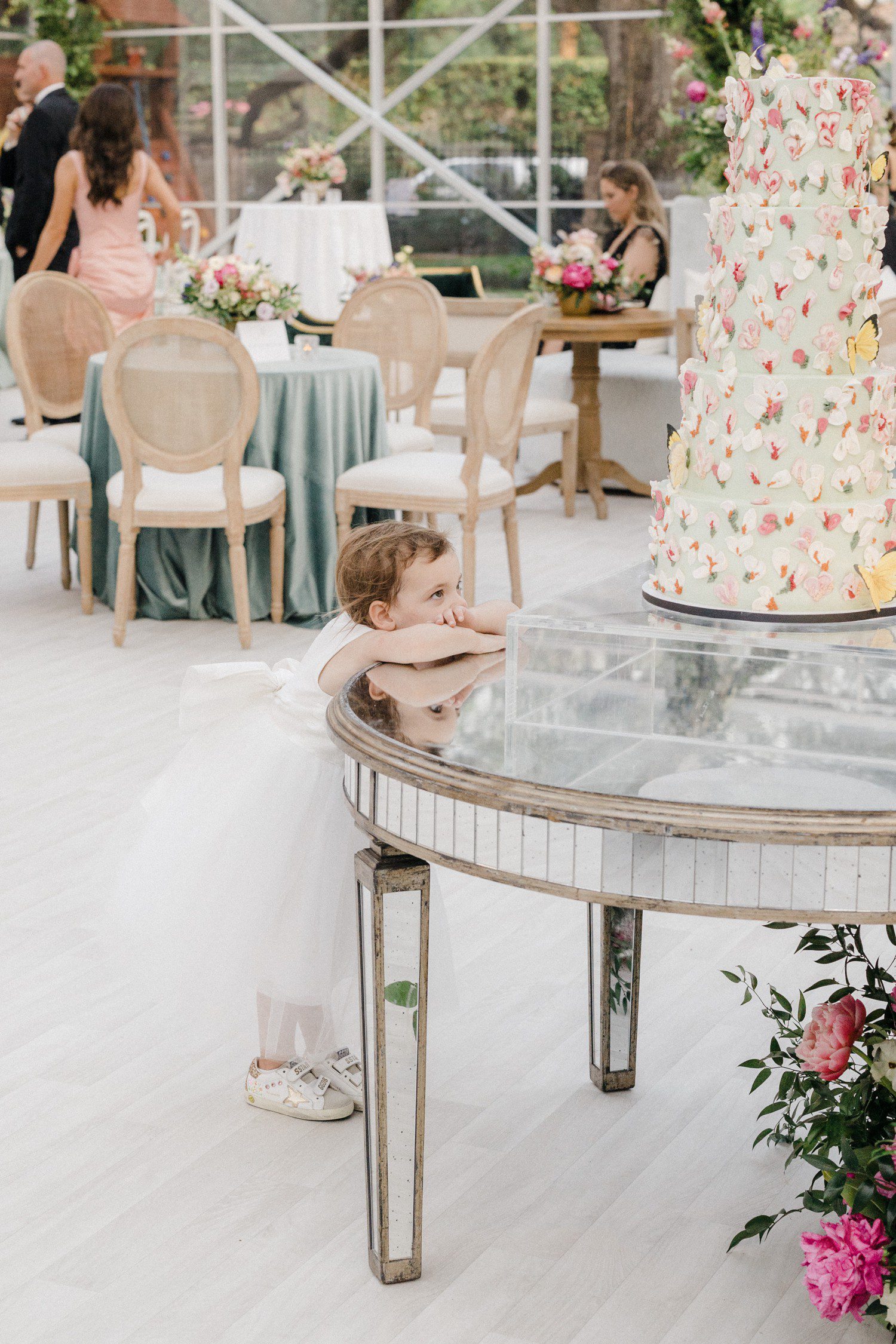 Flower Girl looking at wedding cake