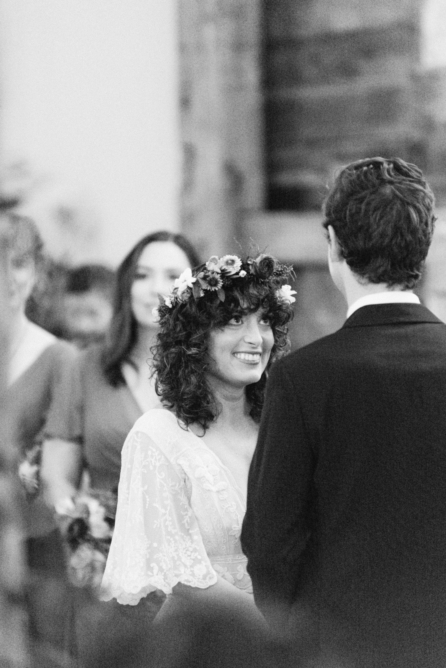 Bride smiling at groom during ceremony