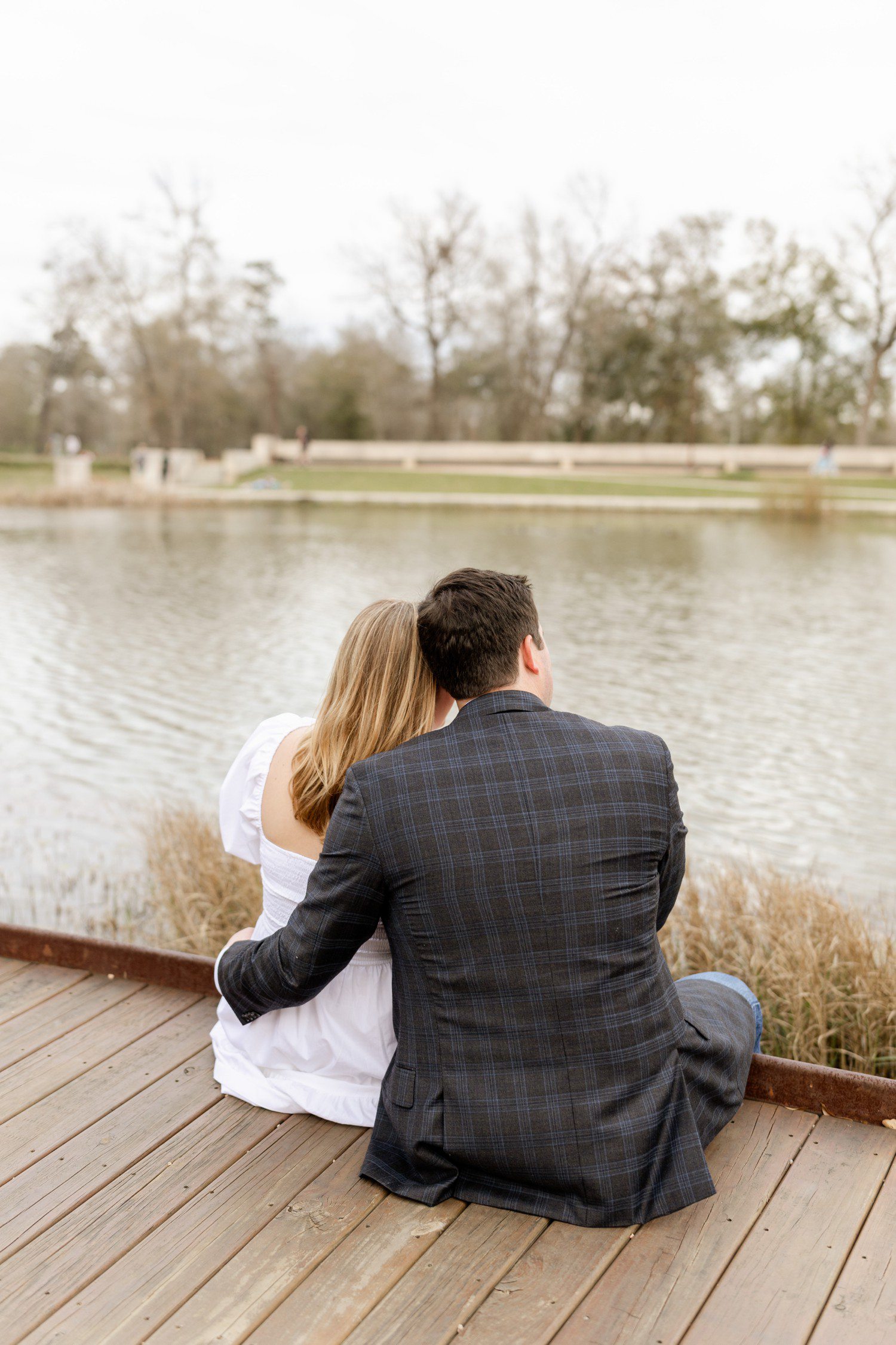 Couple sitting by lake at Eastern Glades Memorial park Houston. 