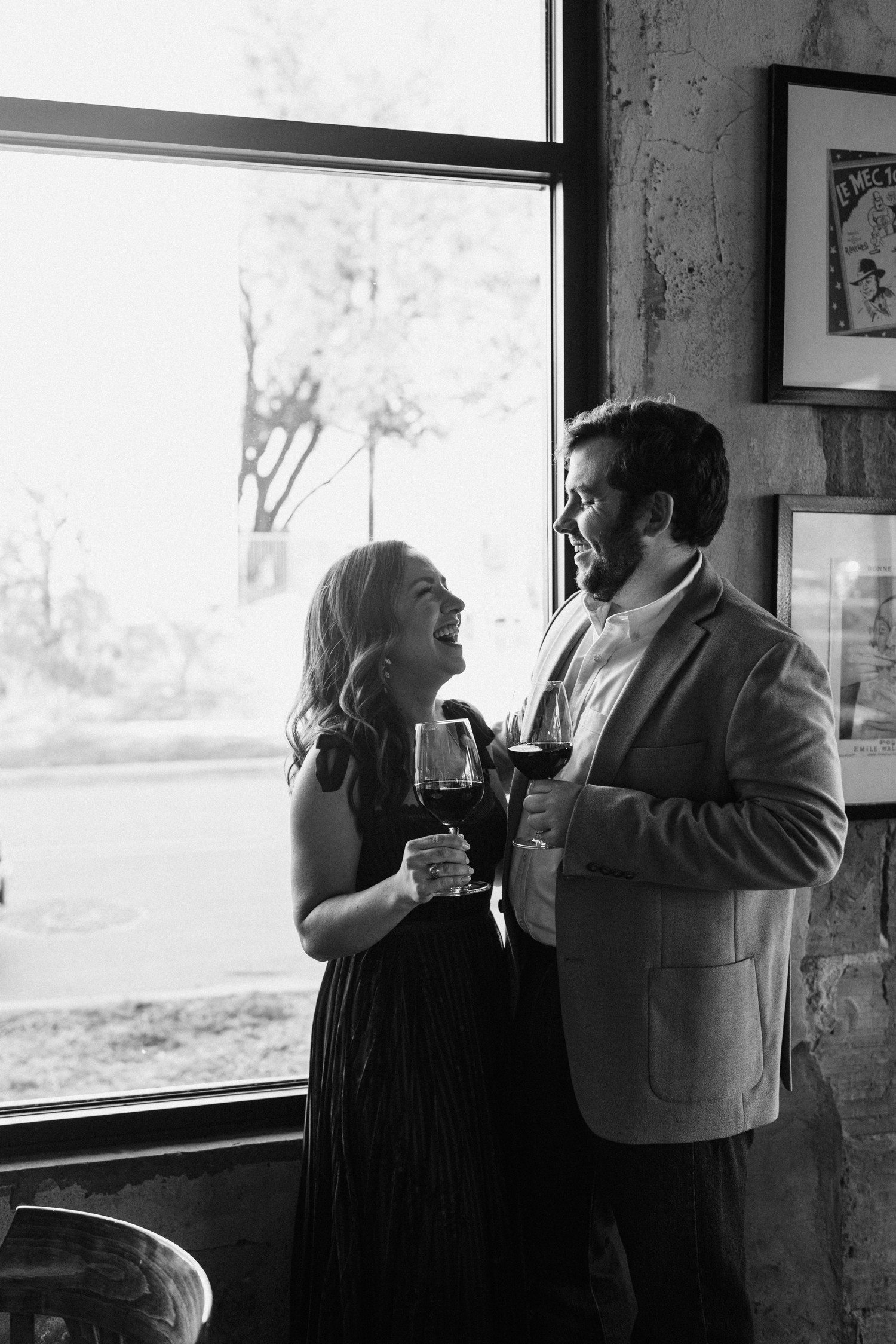 Engagement session at bar in Houston Heights with wine glasses 
