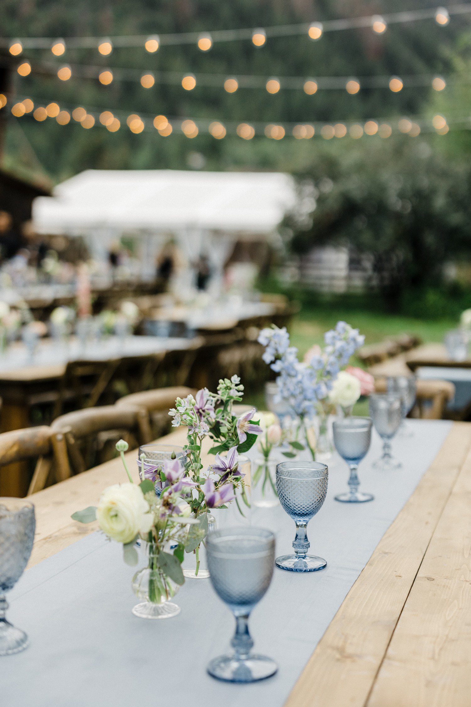 Wedding rehearsal table decorations with florals and light blue table setting. 