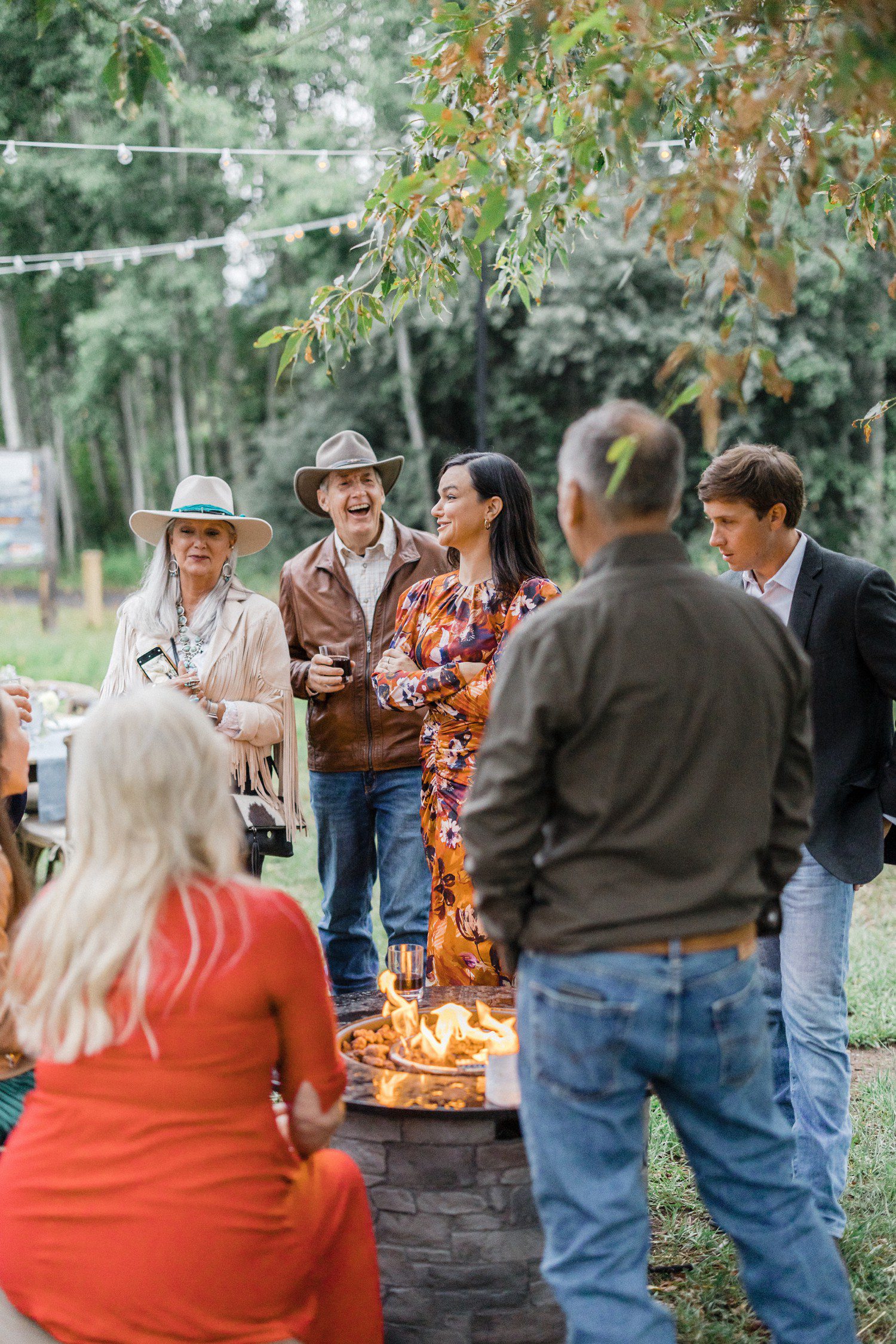 Wedding guests laughing at wedding rehearsal dinner in Aspen. 