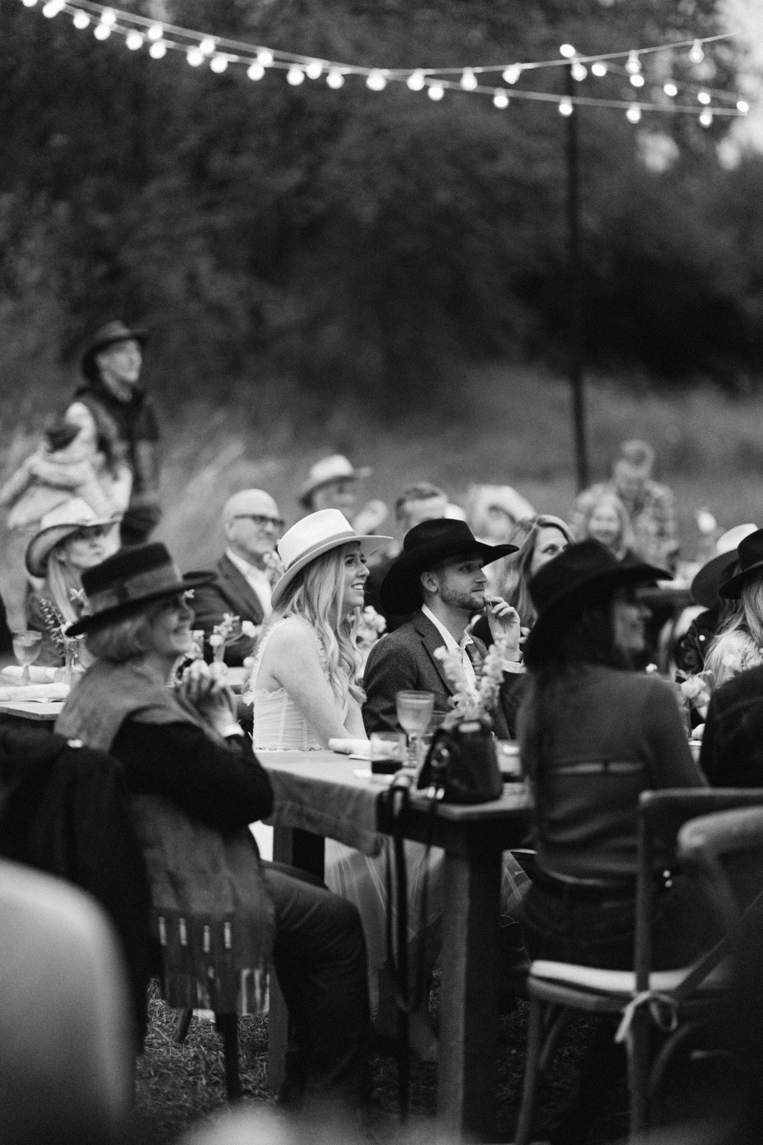 Bride and groom listening to wedding toasts. 