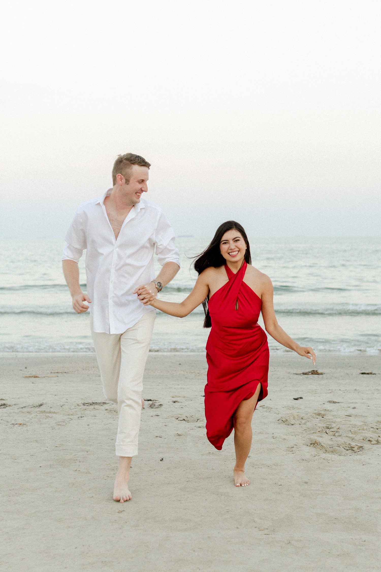 Galveston engagement photos with couple walking on the beach. 