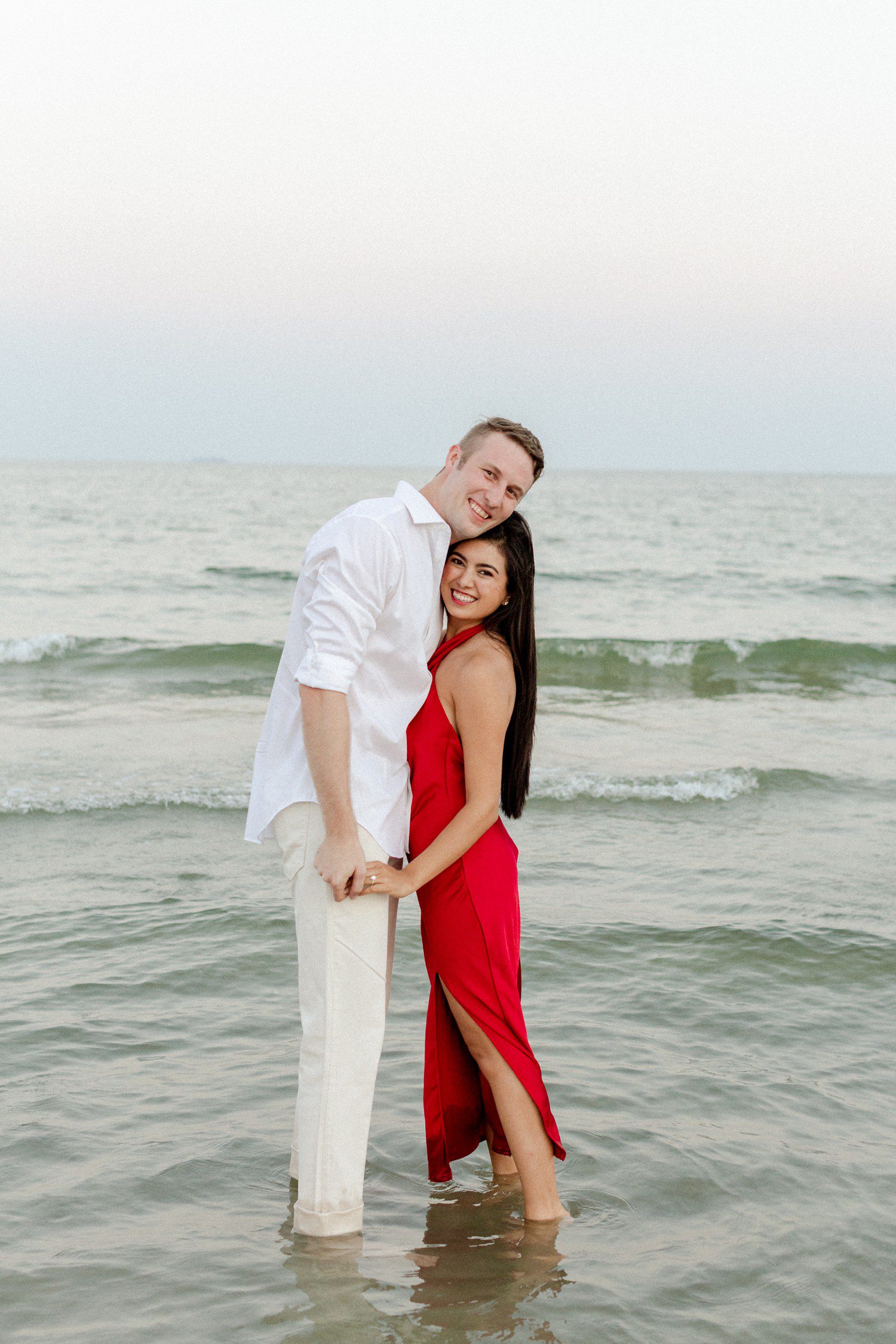 Couple smiling at the camera for engagement session in Galveston