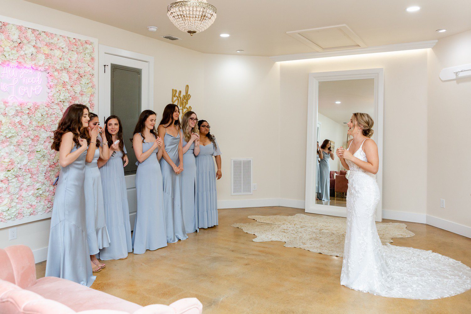 Bride first look with bridesmaids in bridal suite at Sendera Springs.