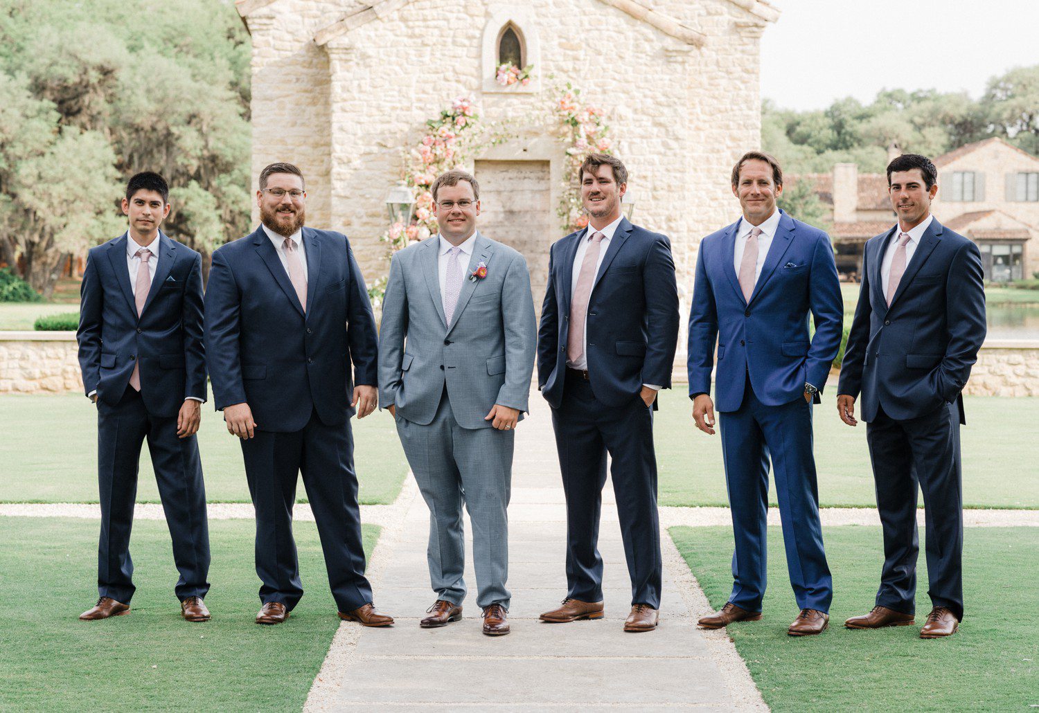 Groomsmen photos in front of the chapel at The Clubs at Houston Oaks. 