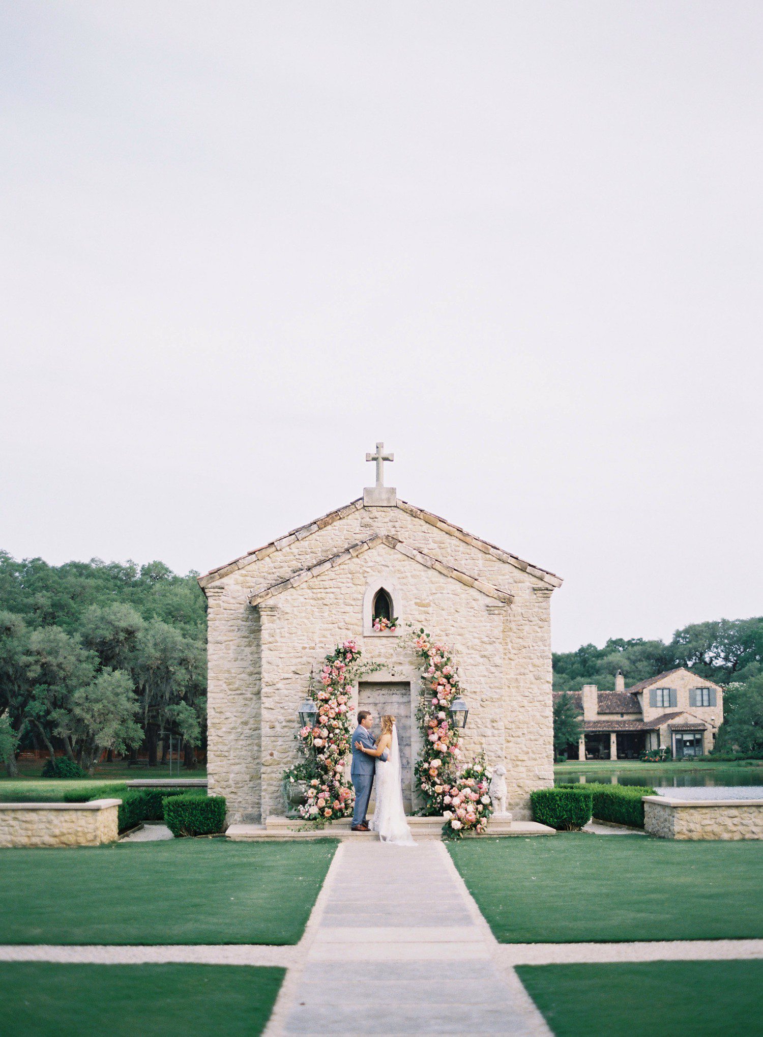 Wedding photos in front of French Chapel at Houston Oaks. 