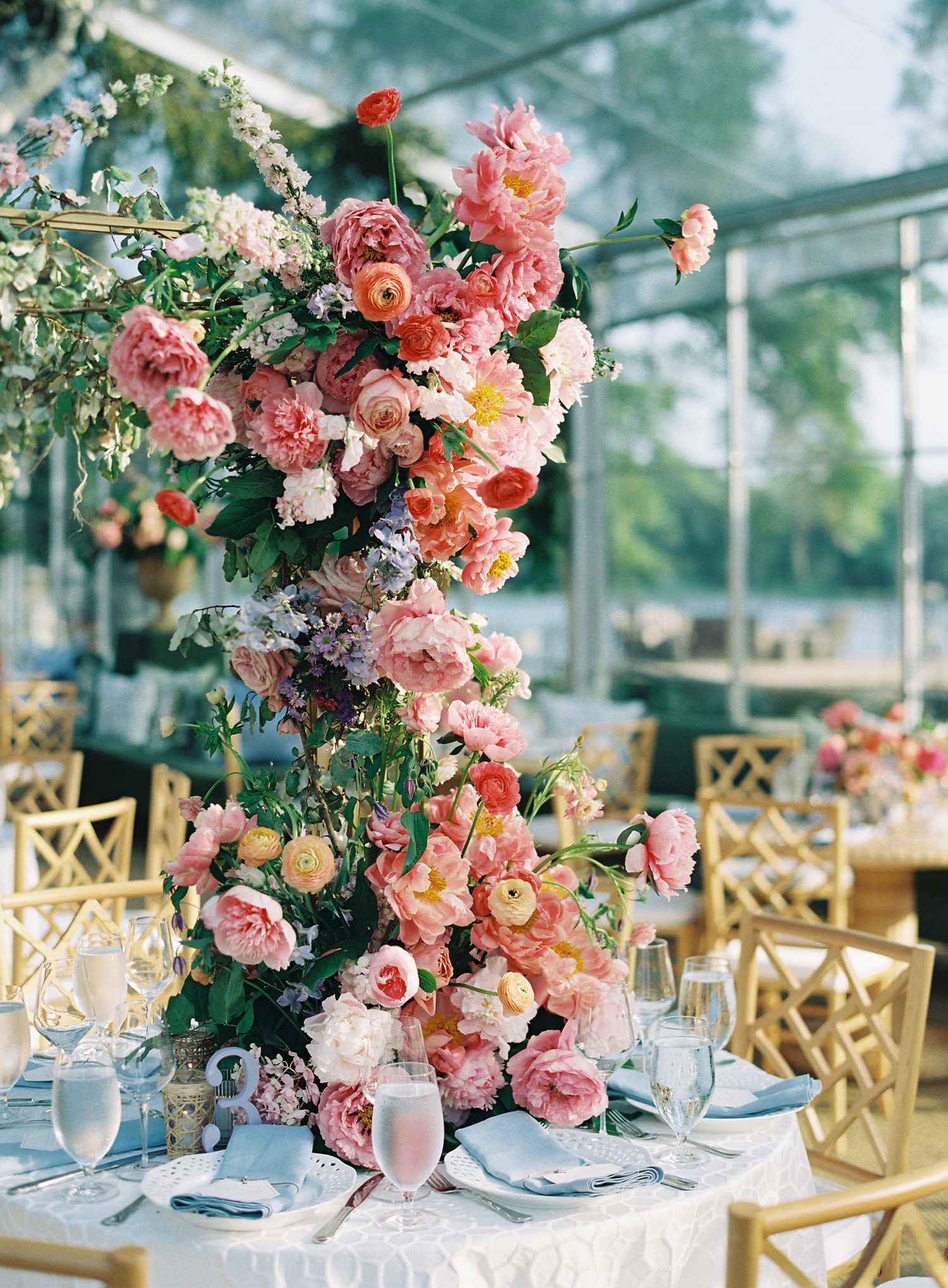 Tower of flowers on table at wedding reception. 
