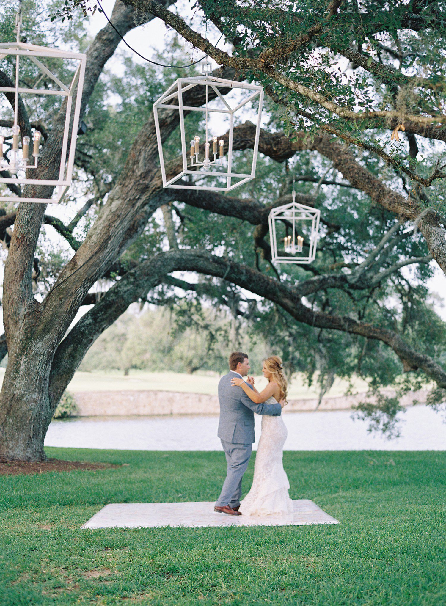 Wedding first dance under oak trees. 