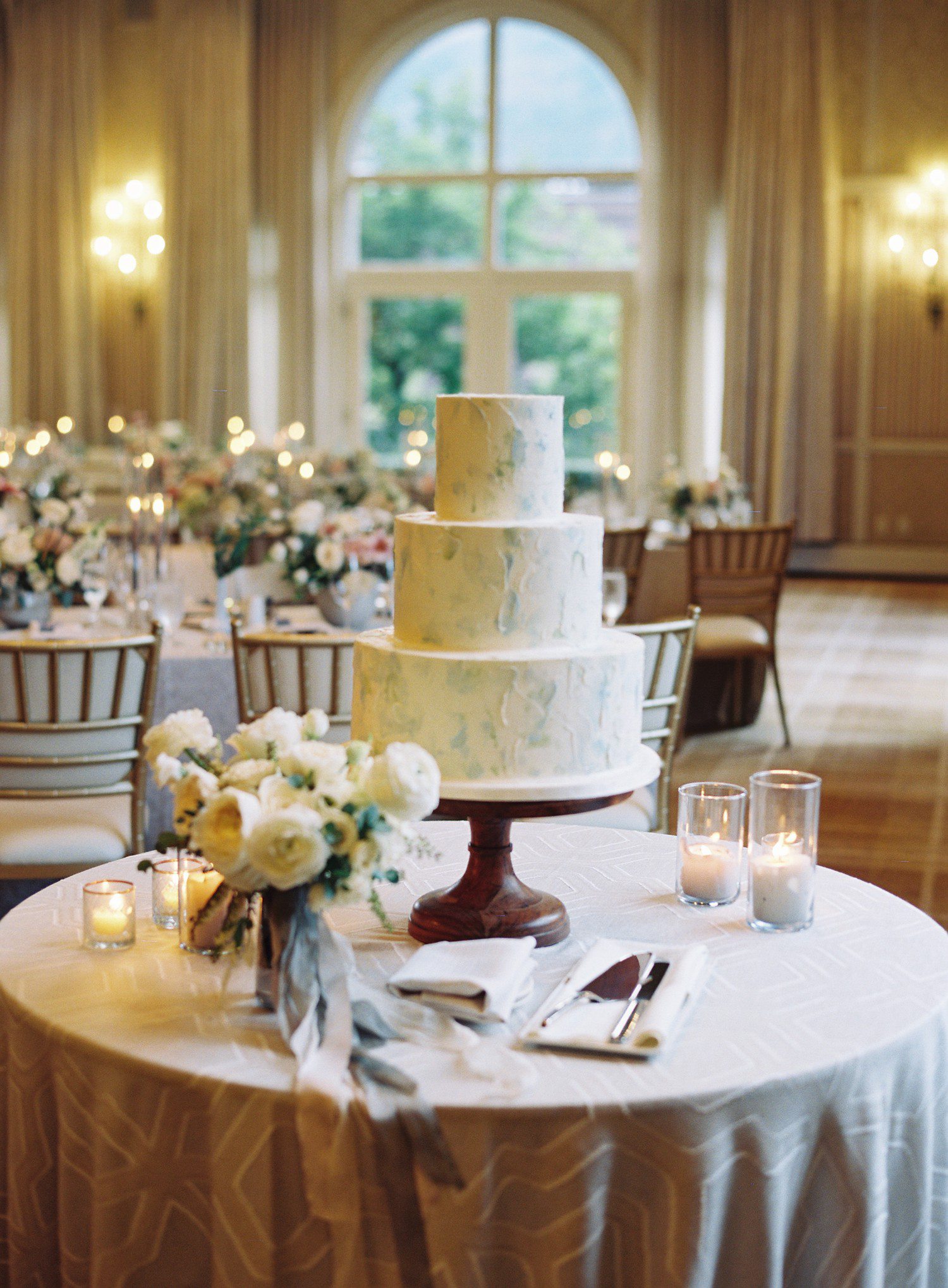 Three tier white wedding cake. 