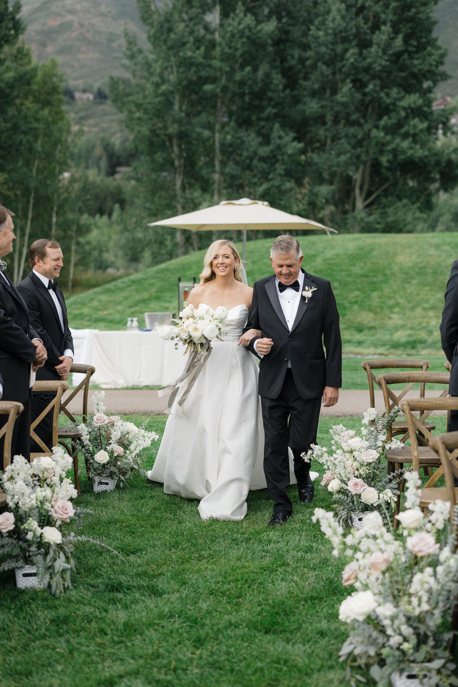 Bride and father walking down aisle at Aspen Meadows Resort. 