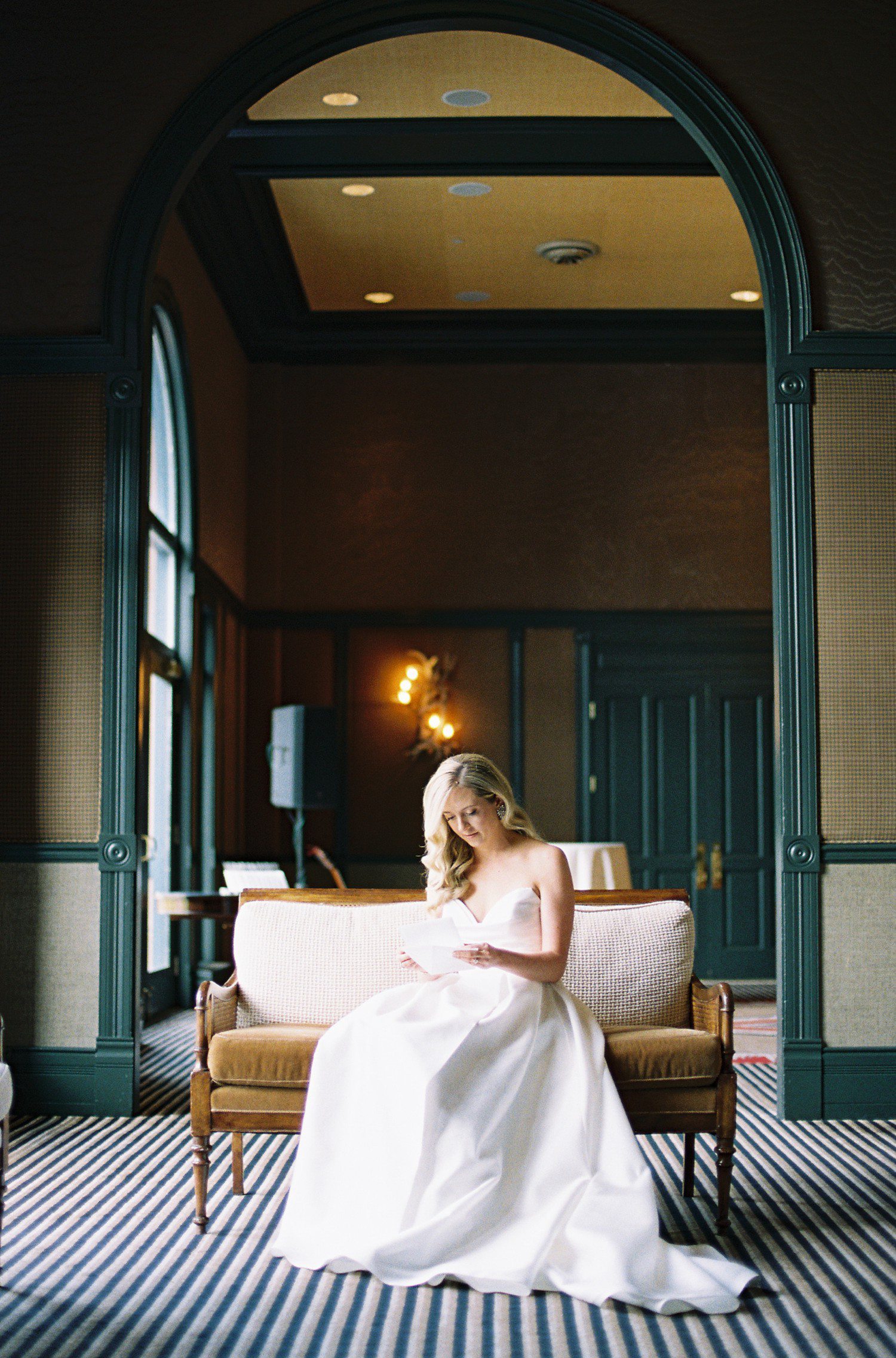 Bride reading letter at Hotel Jerome. 