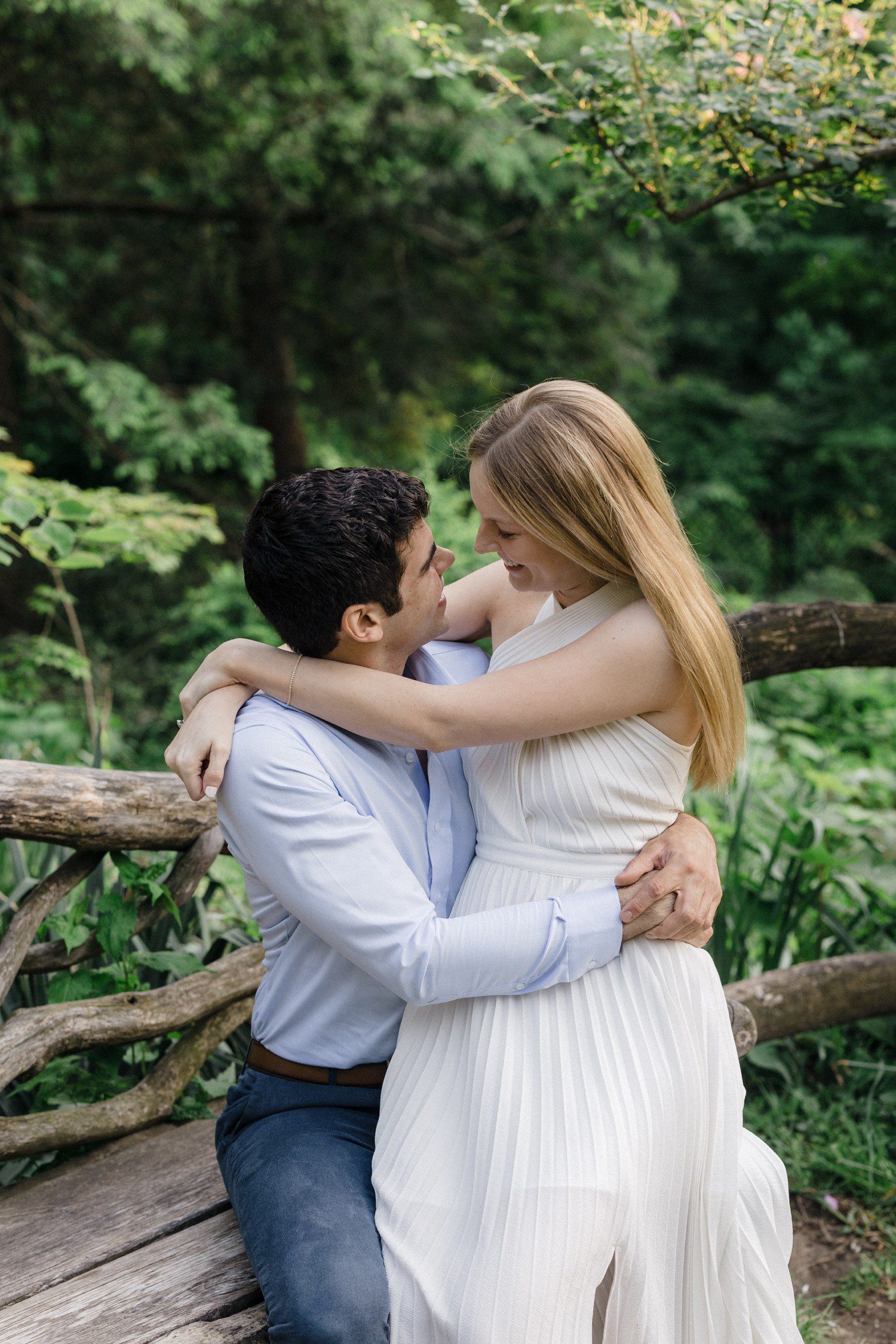 Couple together in Central Park for engagement photos. 