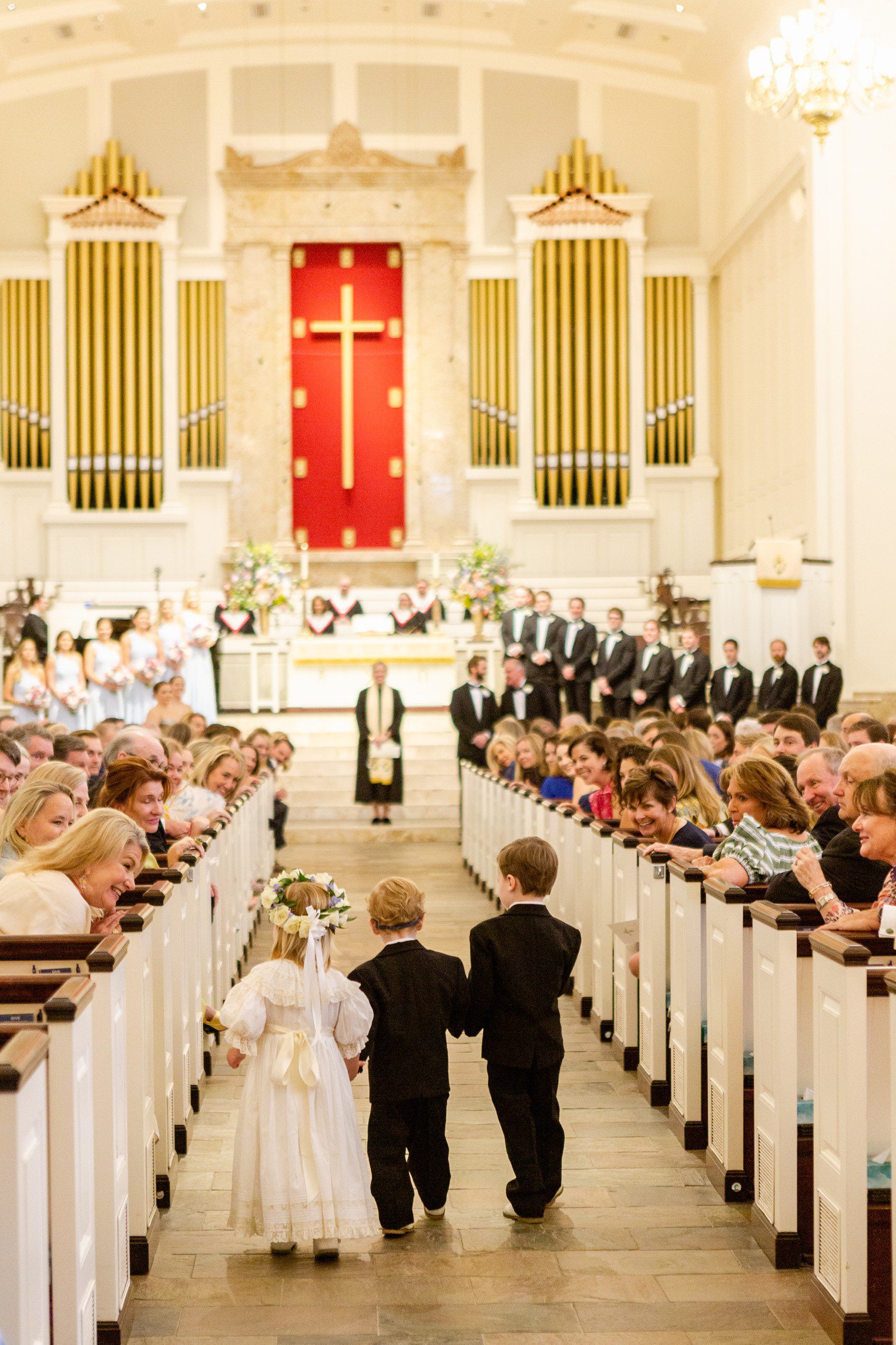 Flower girl and ring bearers walking down aisle for wedding at St. Luke's United Methodist Church in Houston. 