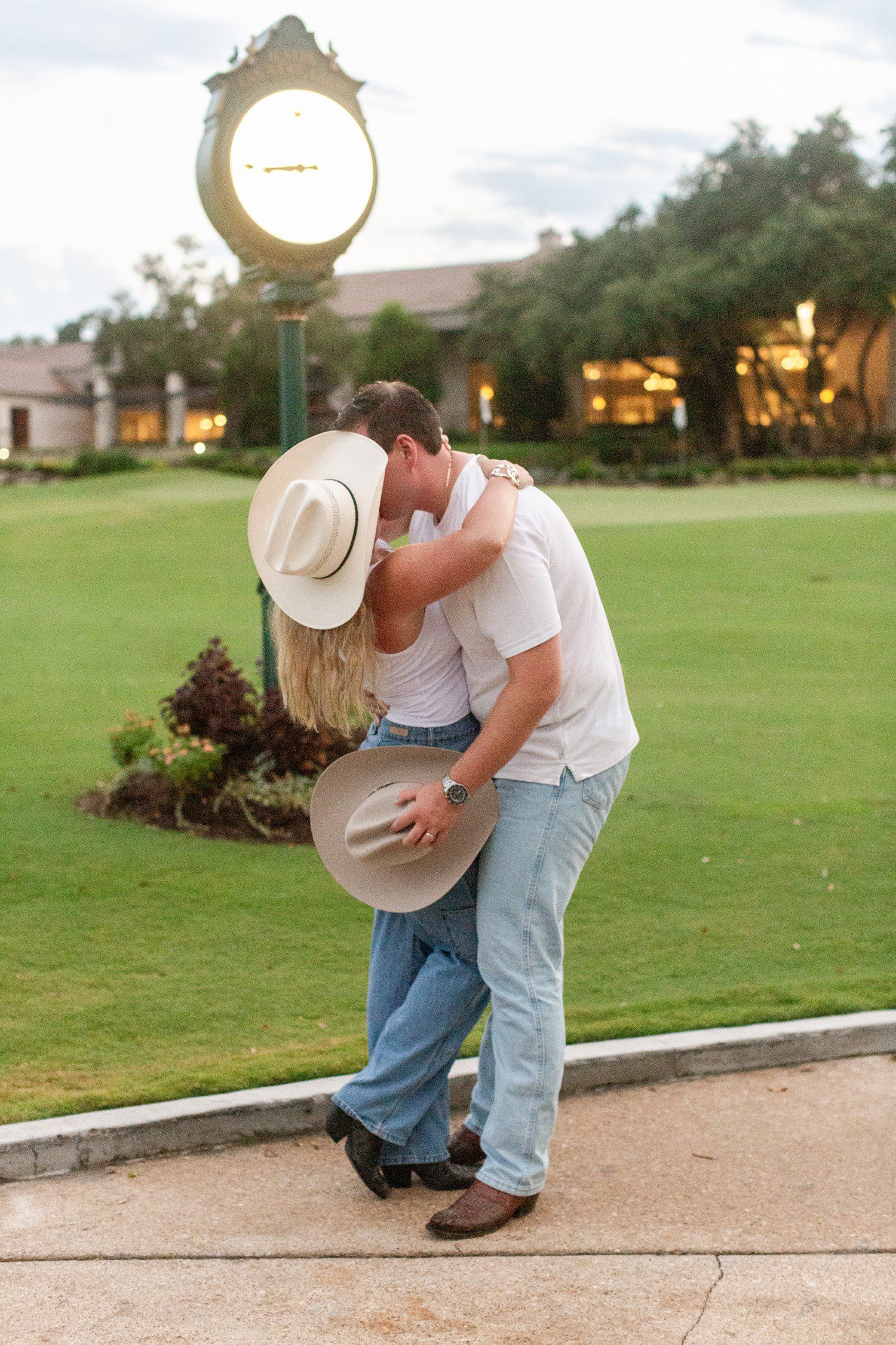 Couple kissing for engagement photos at Austin Country Club. 