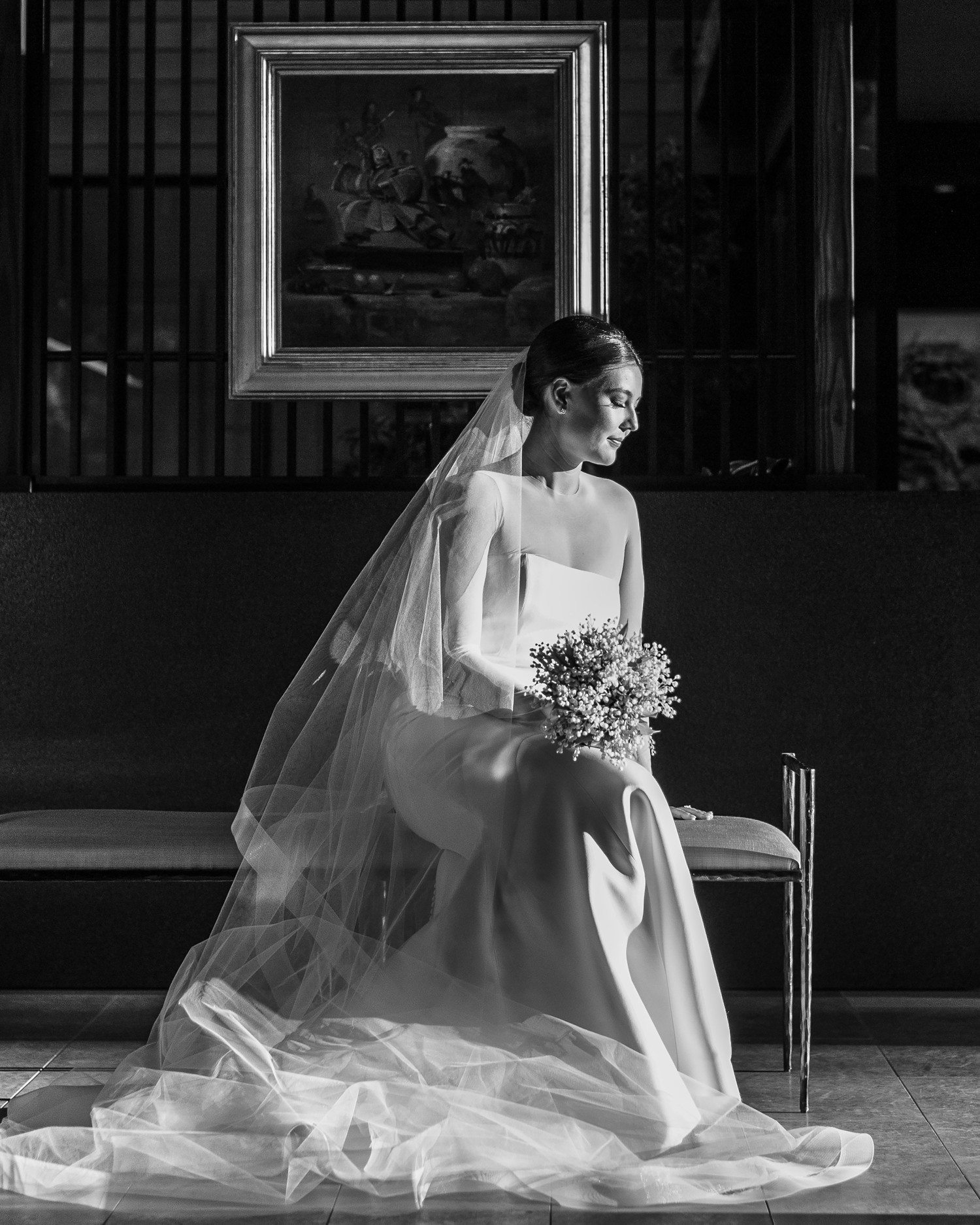 Bride sitting with bouquet and wearing veil for bridal portraits in Houston. 