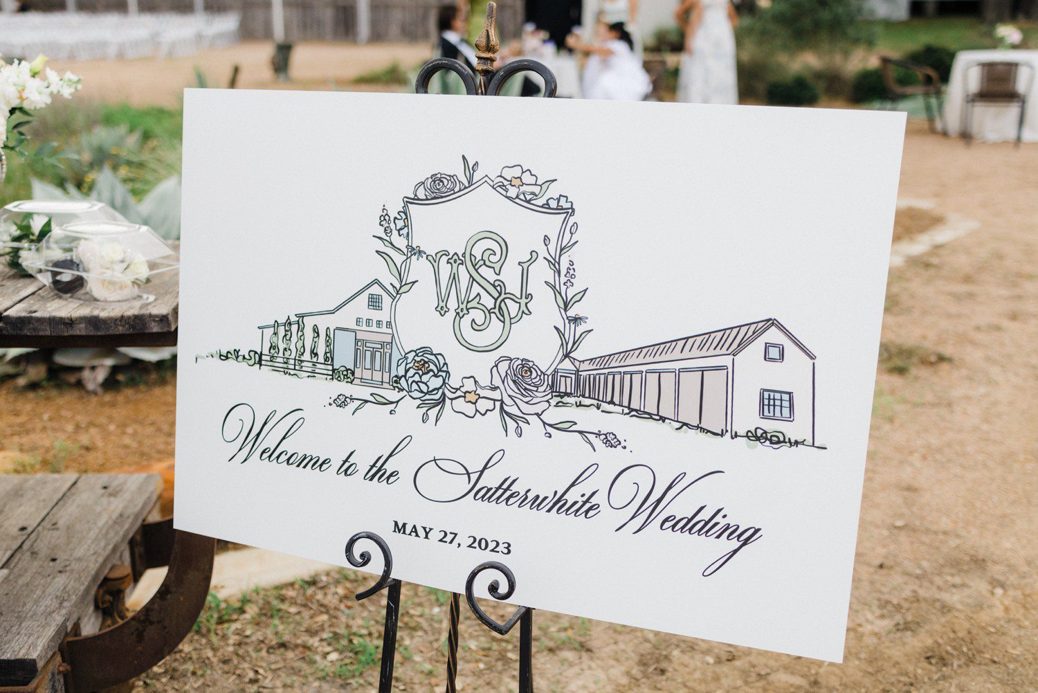 Wedding welcome sign with wedding crest and venue drawing. 