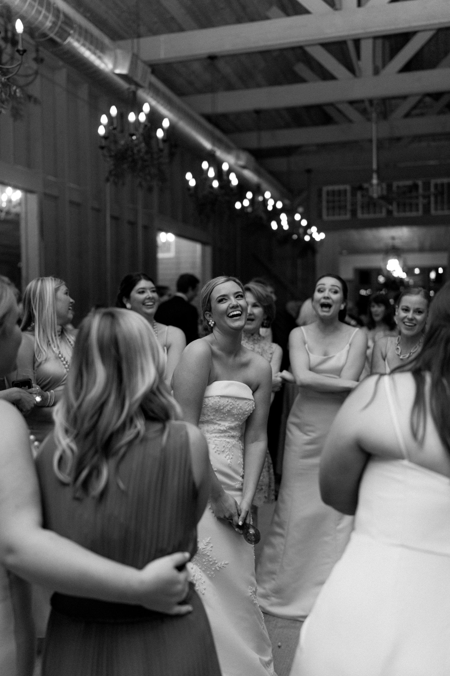 Bride dancing with bridesmaids during wedding reception. 