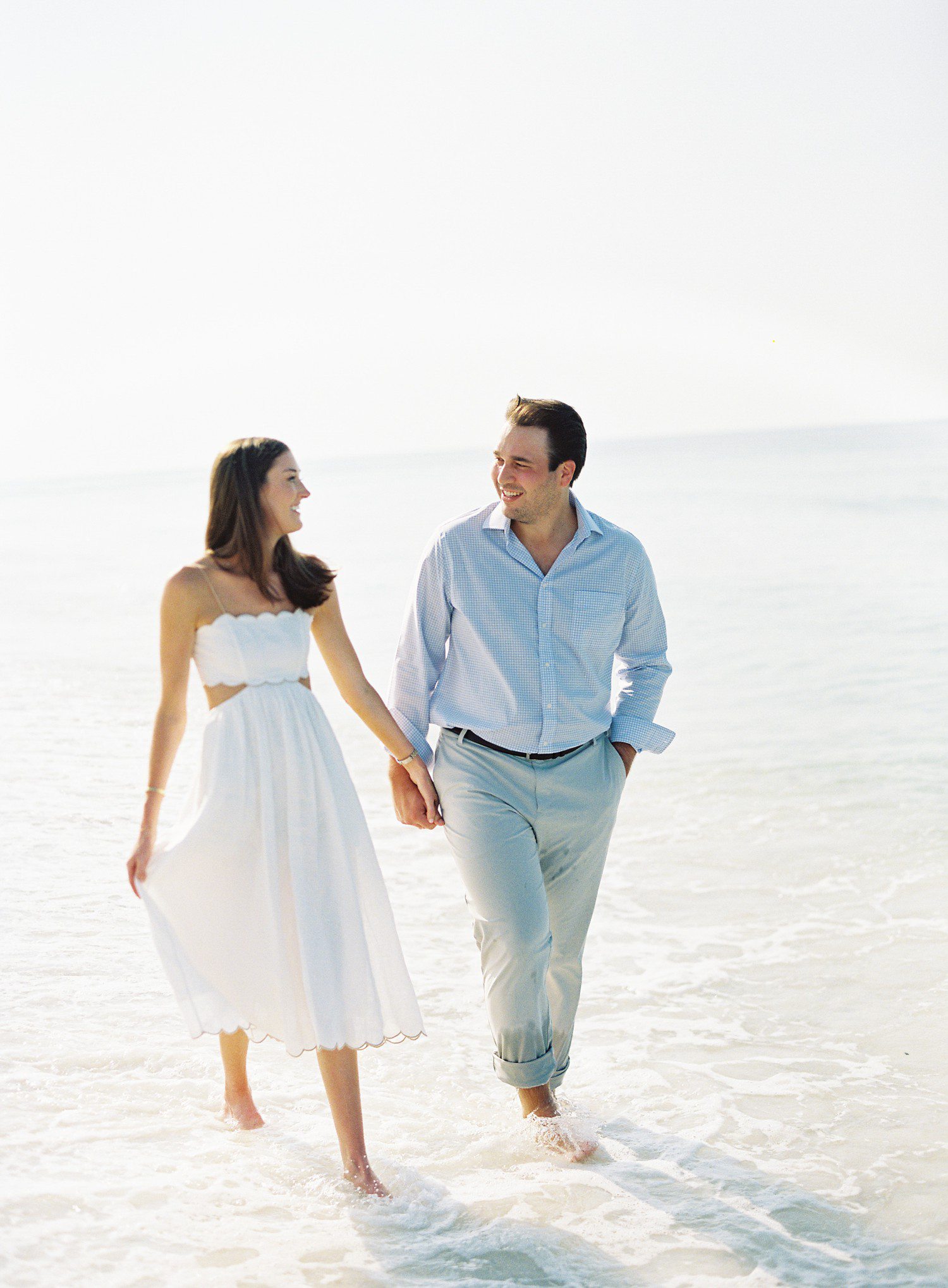 Couple walking on the beach for engagement photos in Seaside FL. 
