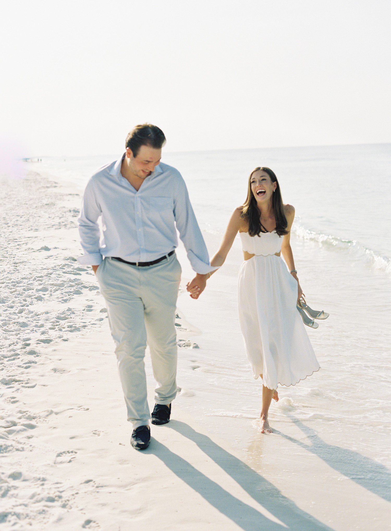 Couple walking on the beach for engagement photos in Watercolor, FL. 