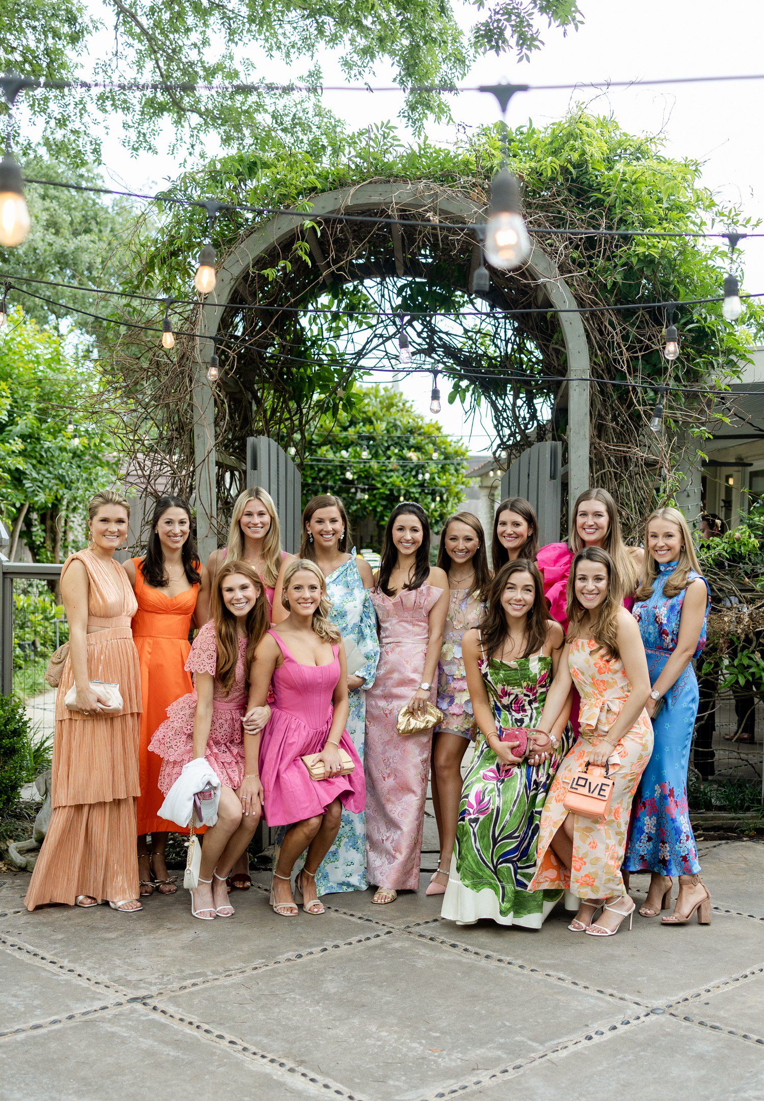 Bride with bridal party at rehearsal dinner in Houston.
