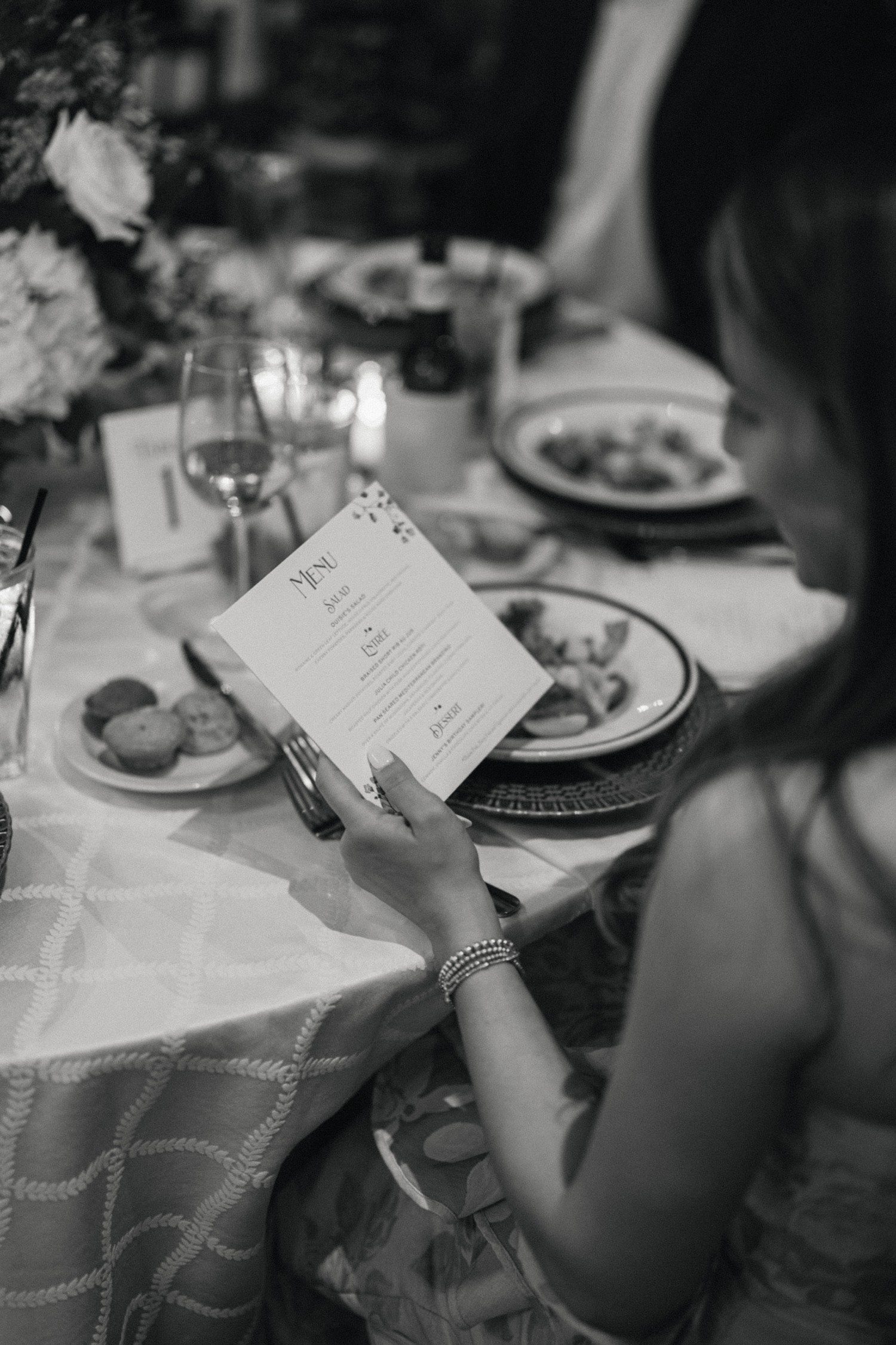 Guest looking at menu for rehearsal dinner.