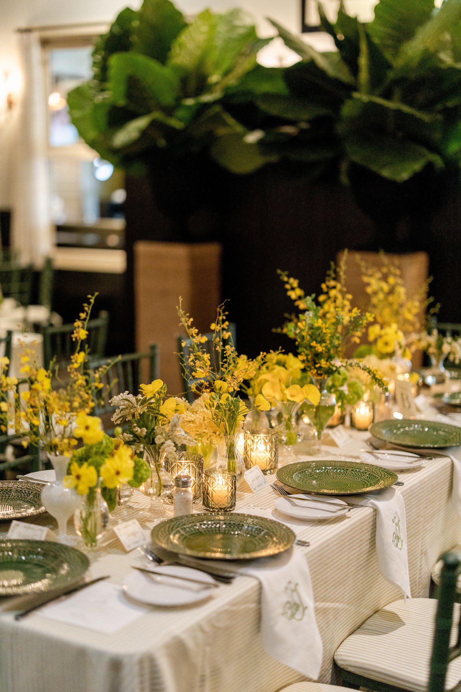 Wedding rehearsal dinner at Ousie's in Houston with yellow flowers decorating tables.