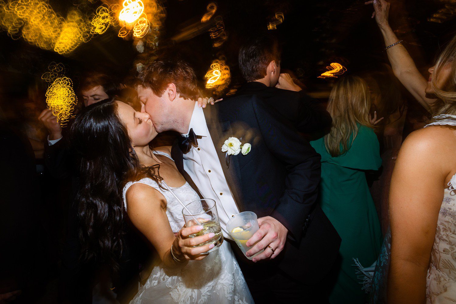 Bride and groom kissing during wedding reception
