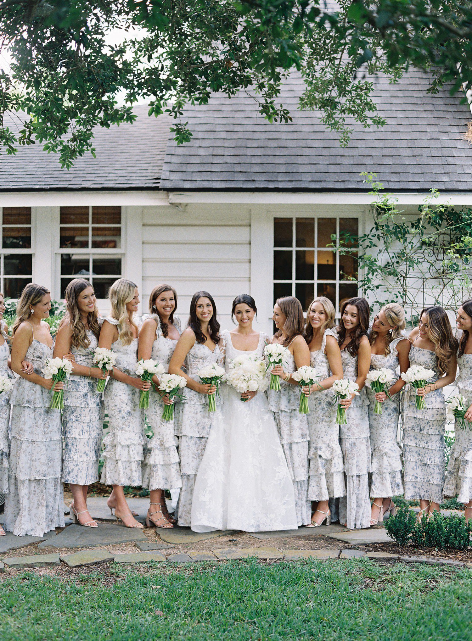 Bride and bridesmaid photos with white floral pattern dress and white bouquets.