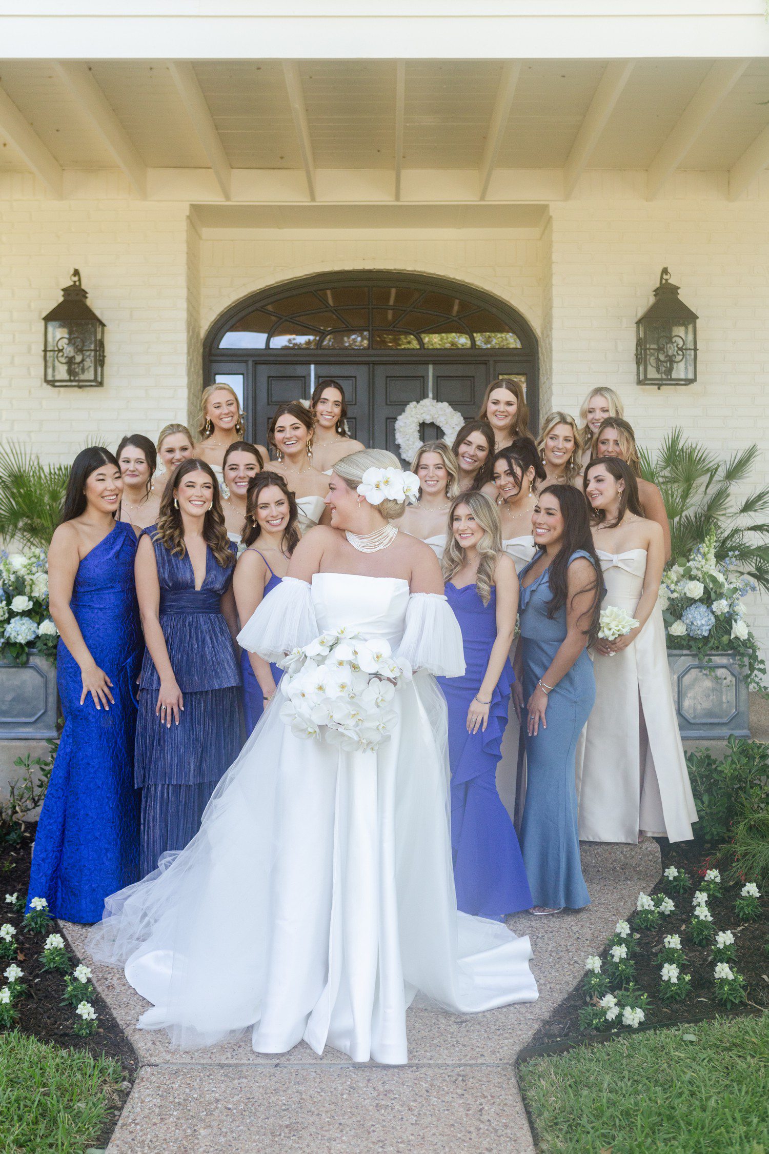 Bride and bridesmaids in blue and champagne bridesmaid dresses.
