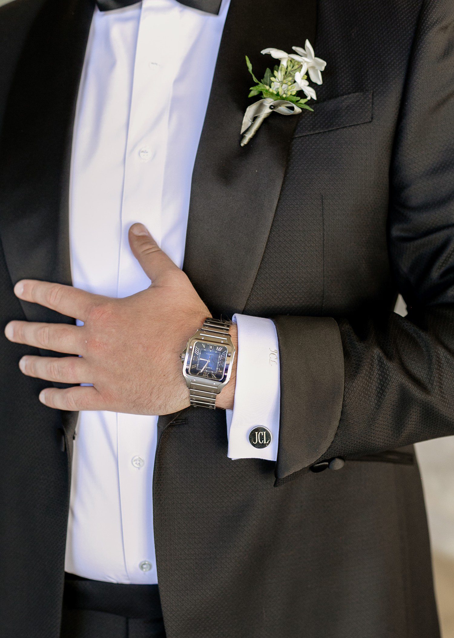 Groom wearing Cartier watch and cuff links.