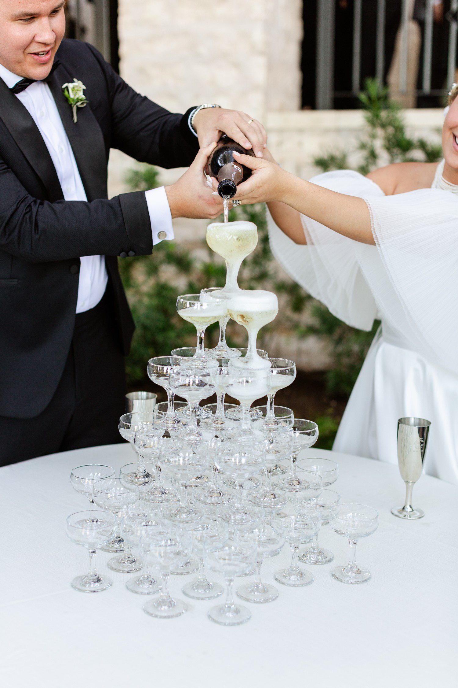 Bride and groom pouring a champagne tower.