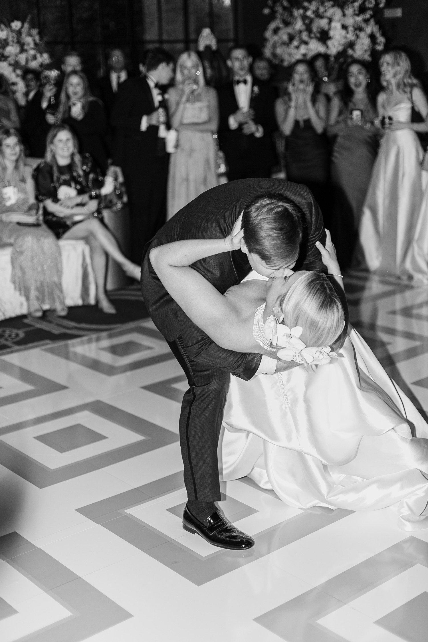 Groom dipping bride for kiss during first dance.