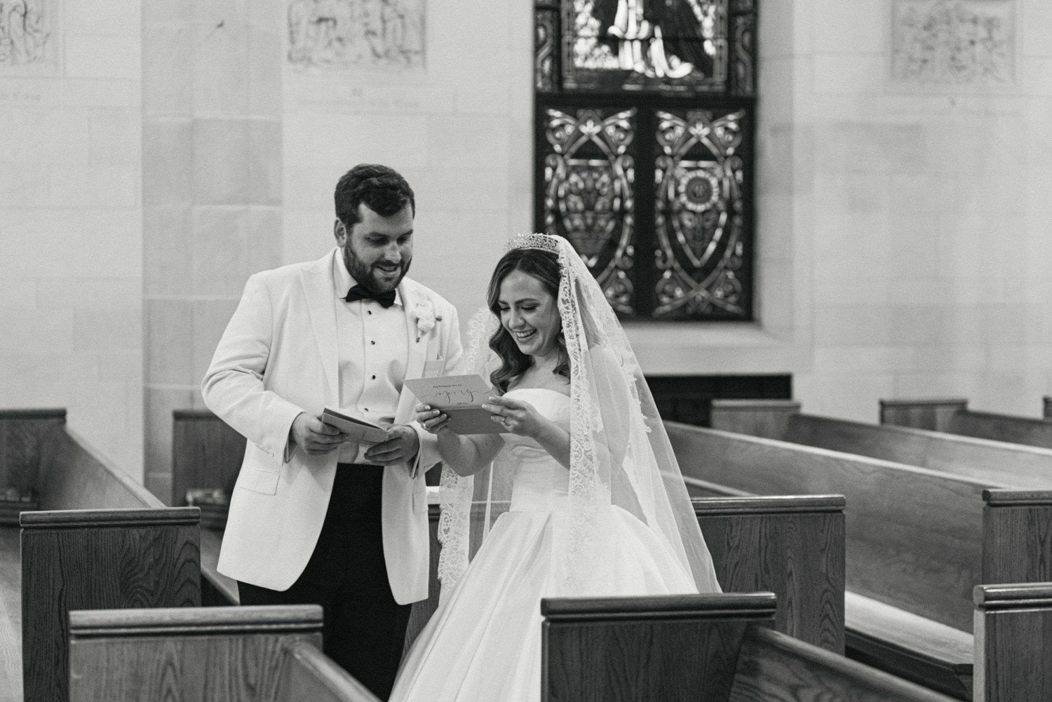 Bride and groom exchanging cards and letters on wedding day.