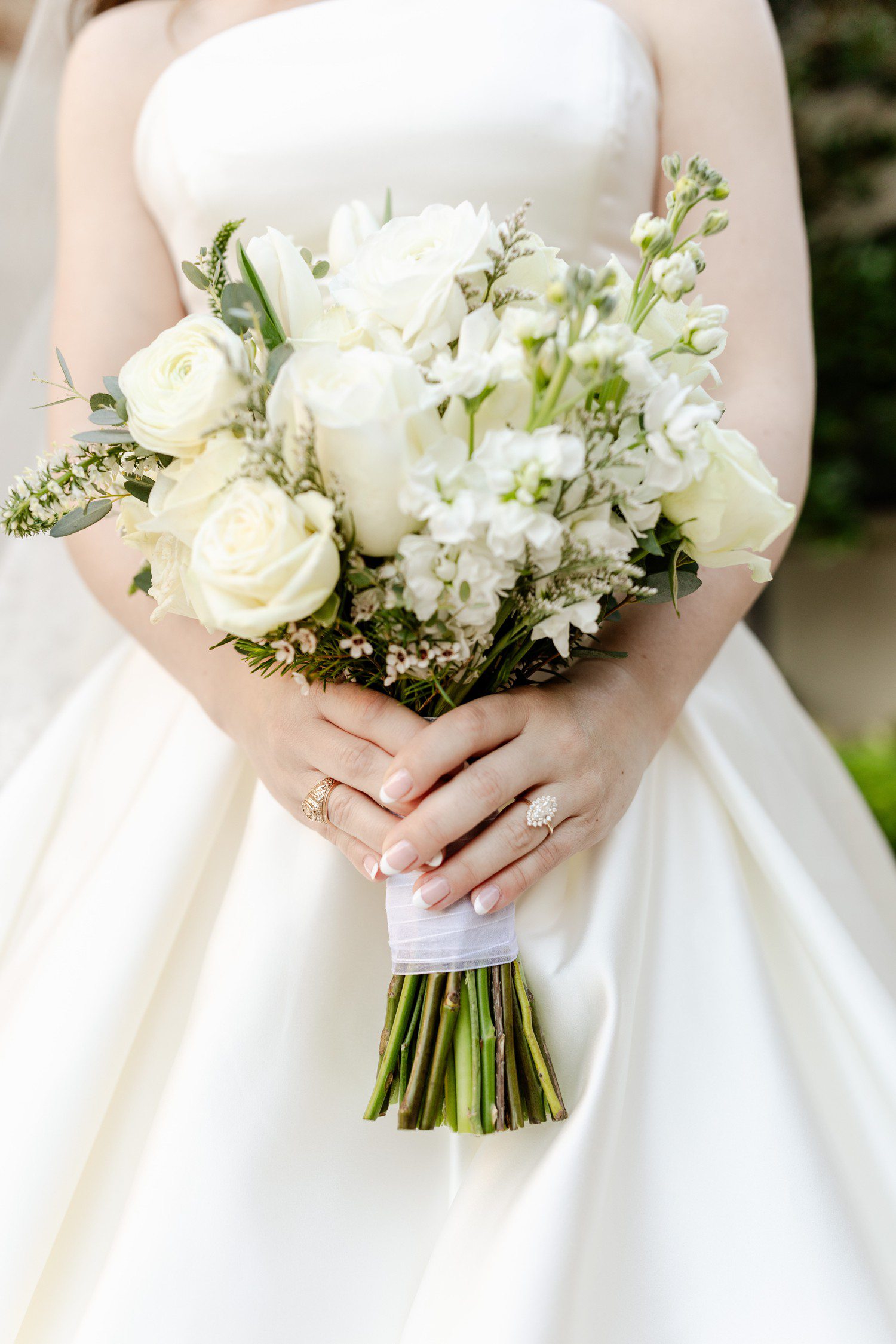 Bride holding white bridal bouquet.