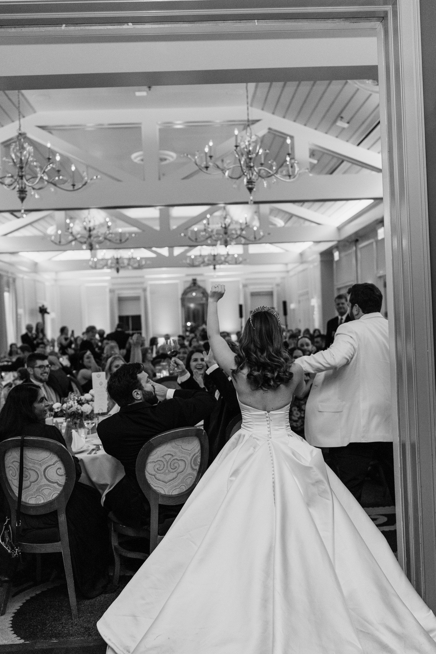 Bride and groom entering wedding reception at Brennan's of Houston.
