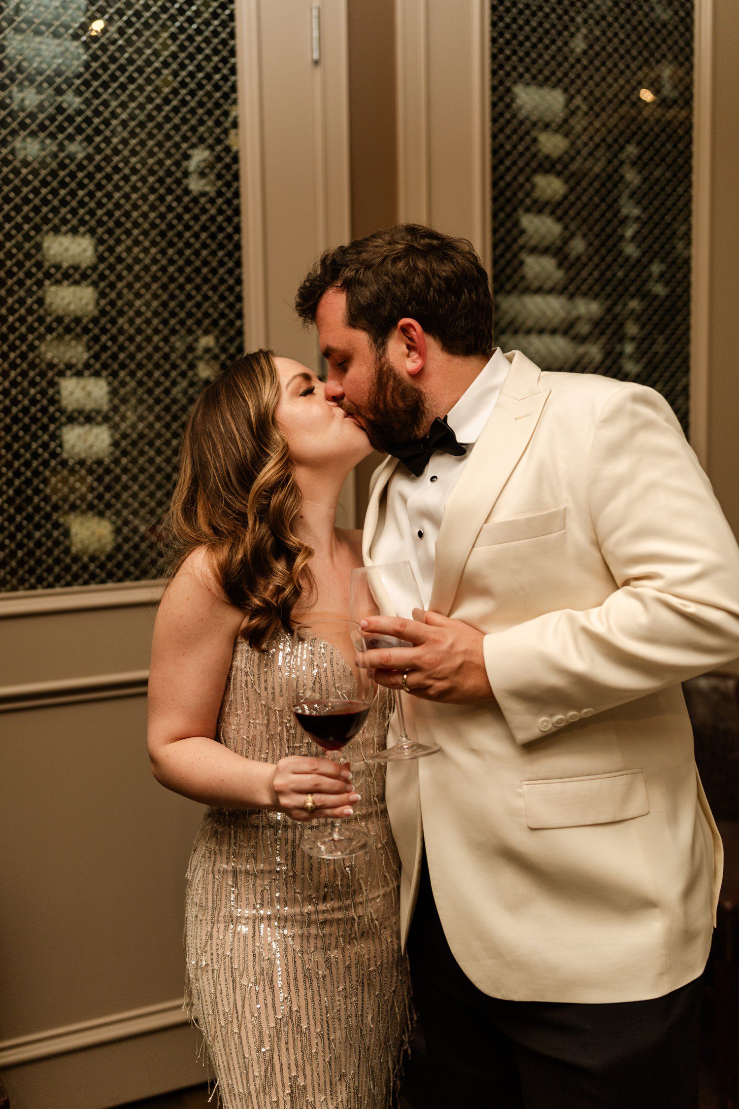 Bride and groom kissing at wedding reception at Brennan's of Houston.