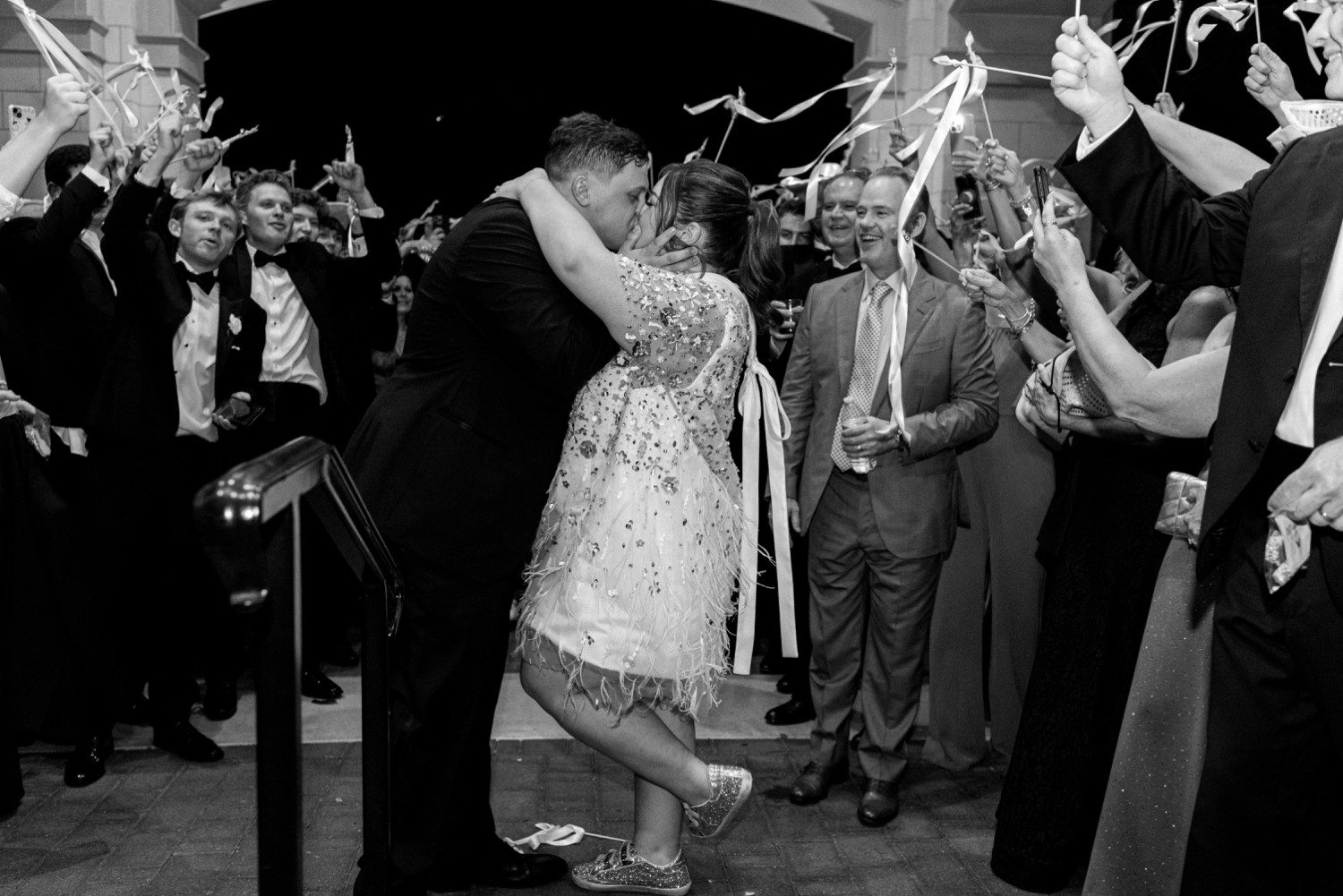 Bride and groom kissing during wedding exit at Lakeside Country Club in Houston. 