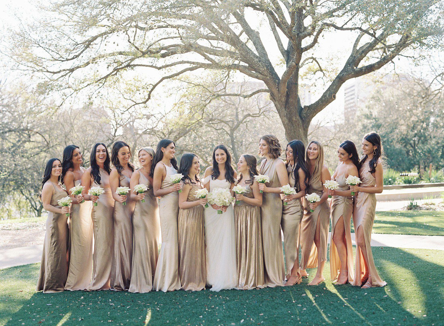Bride and bridesmaids photos at Four Seasons in Austin with bridesmaids in champagne dresses. 