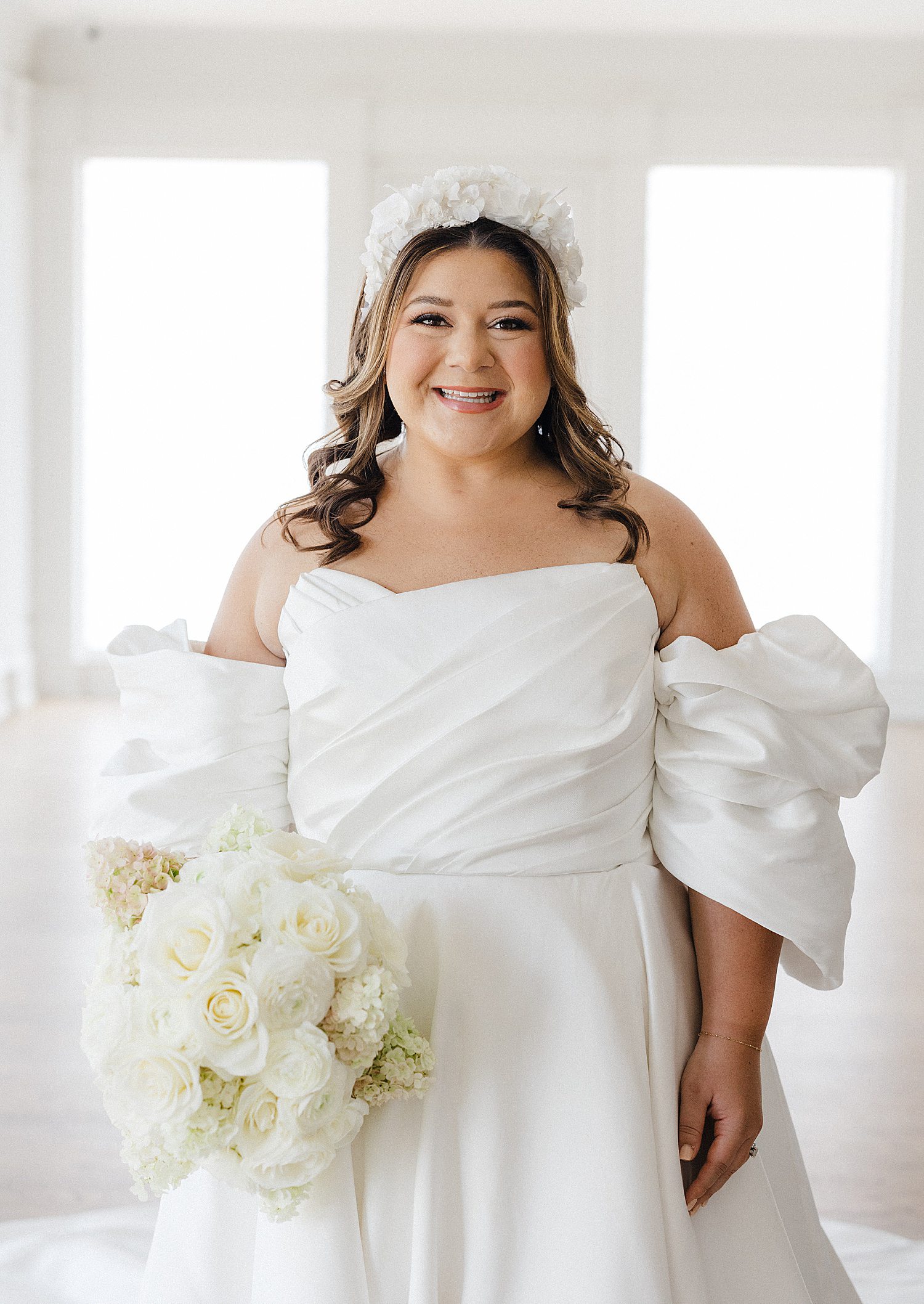 Bride with floral headband and white rose bouquet