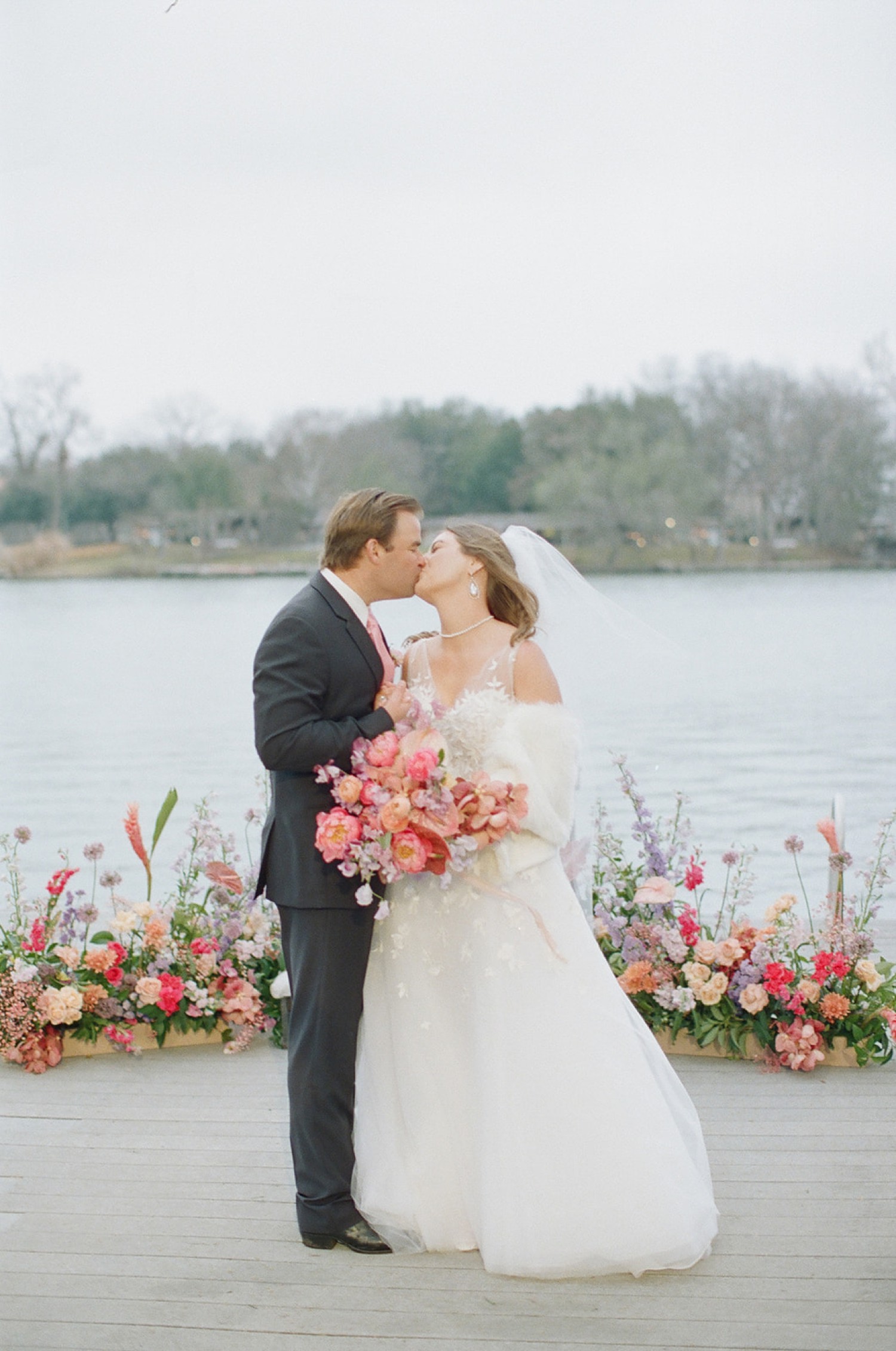 Texas Winter Wedding Bride and Groom Kissing on Lake