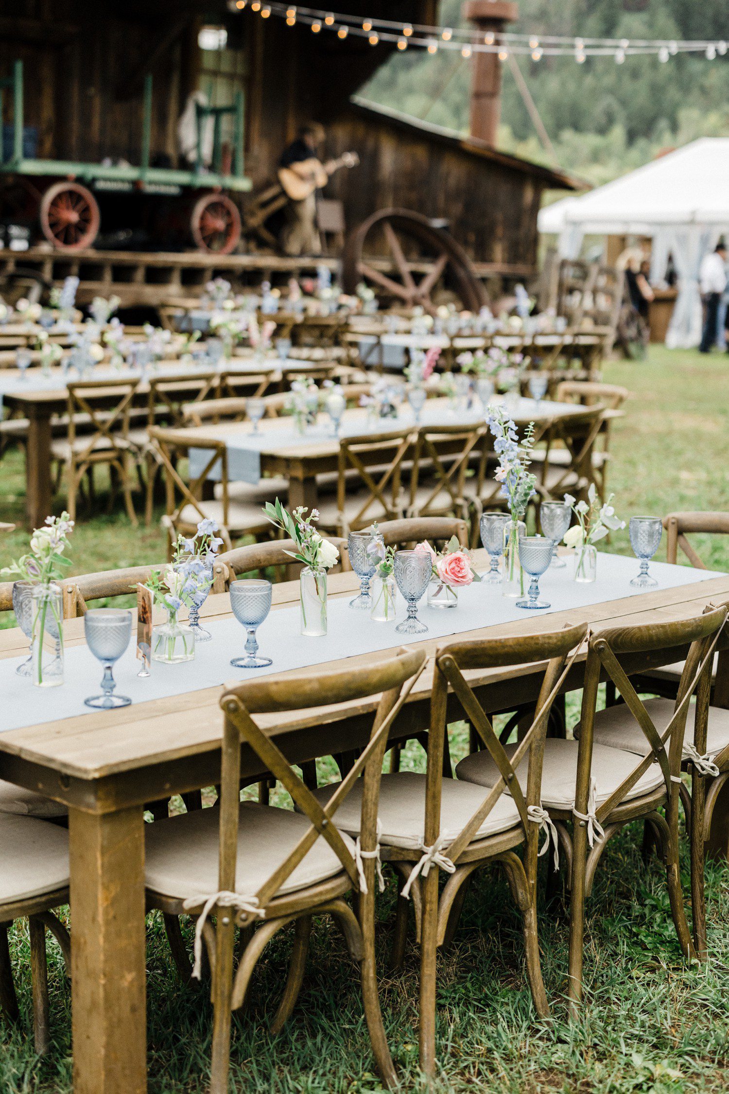 Wedding rehearsal dinner set-up with flowers and light blue decor.