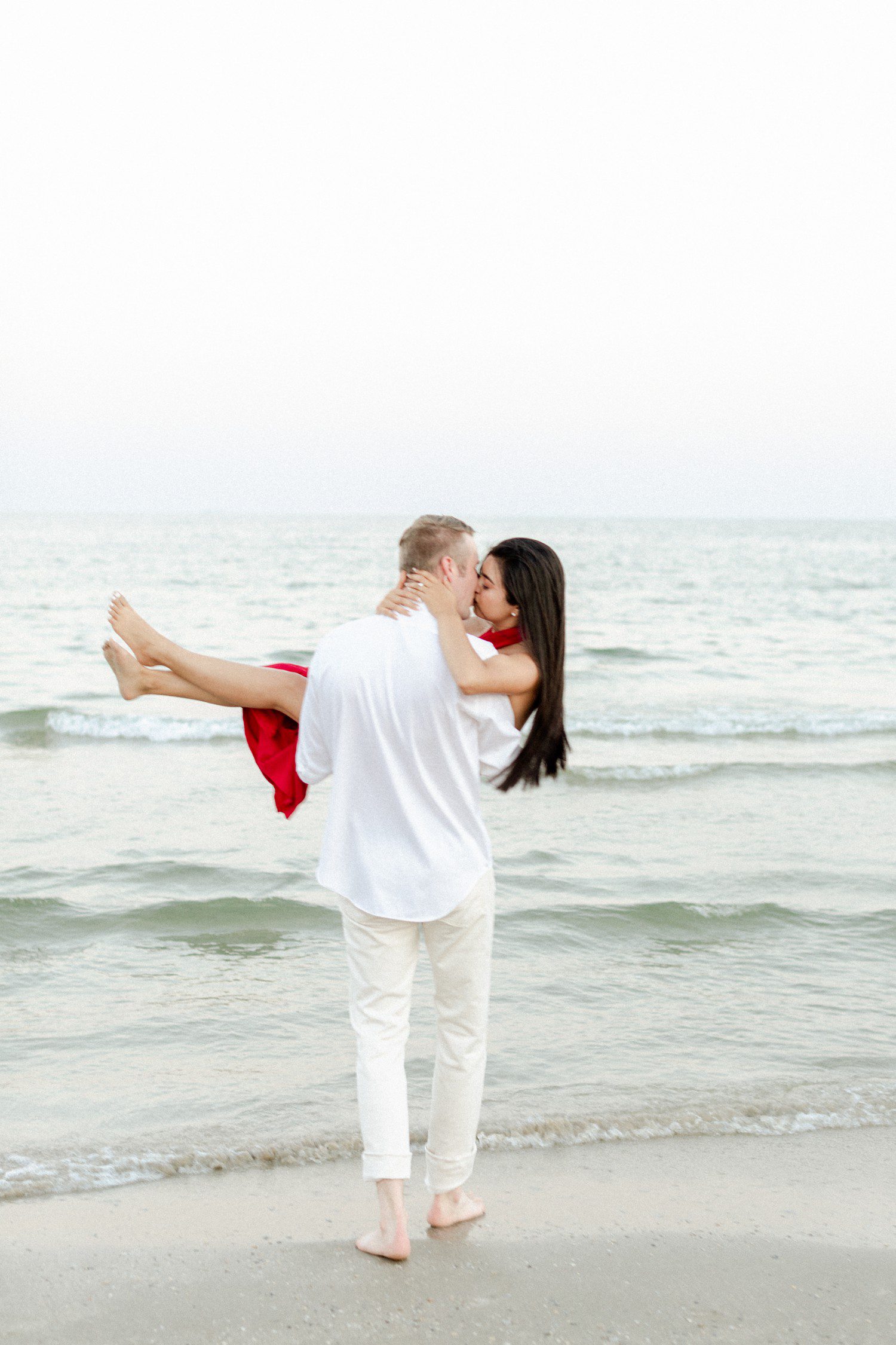 Galveston beach engagement photos with couple kissing.