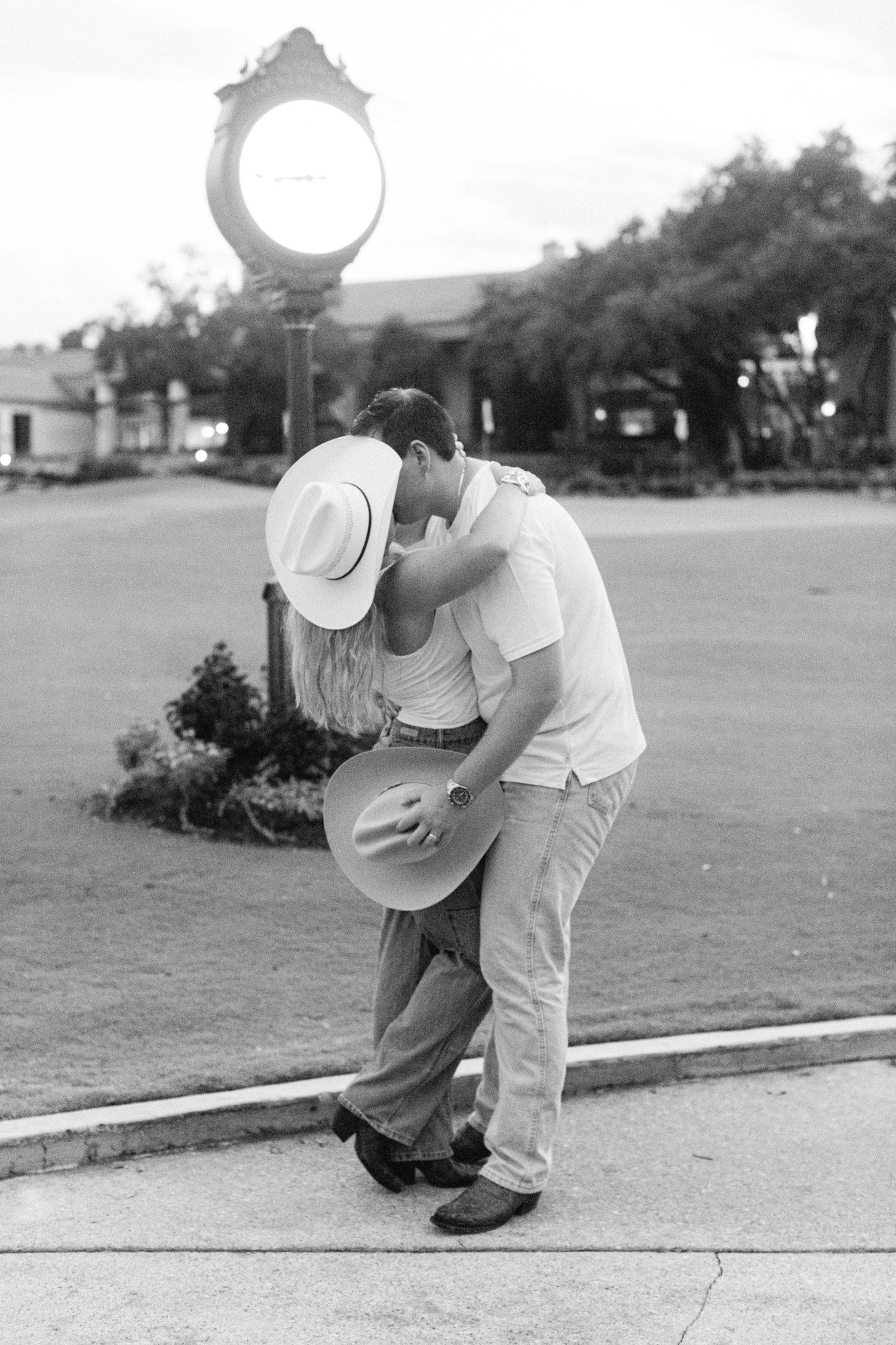 Couple kissing for engagement photos at Austin Country Club.