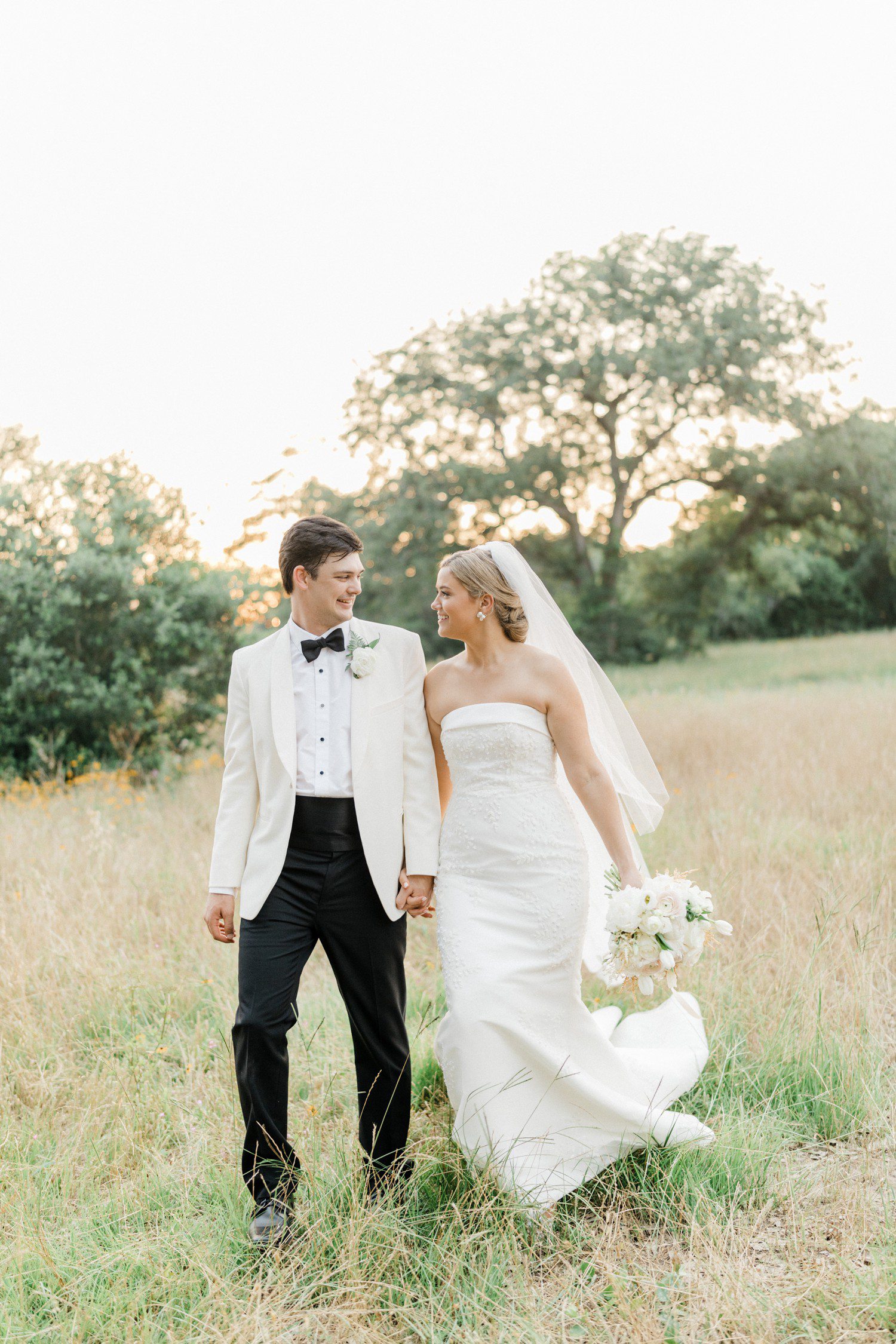 Bride and groom walking together at The Compound in Round Top TX.